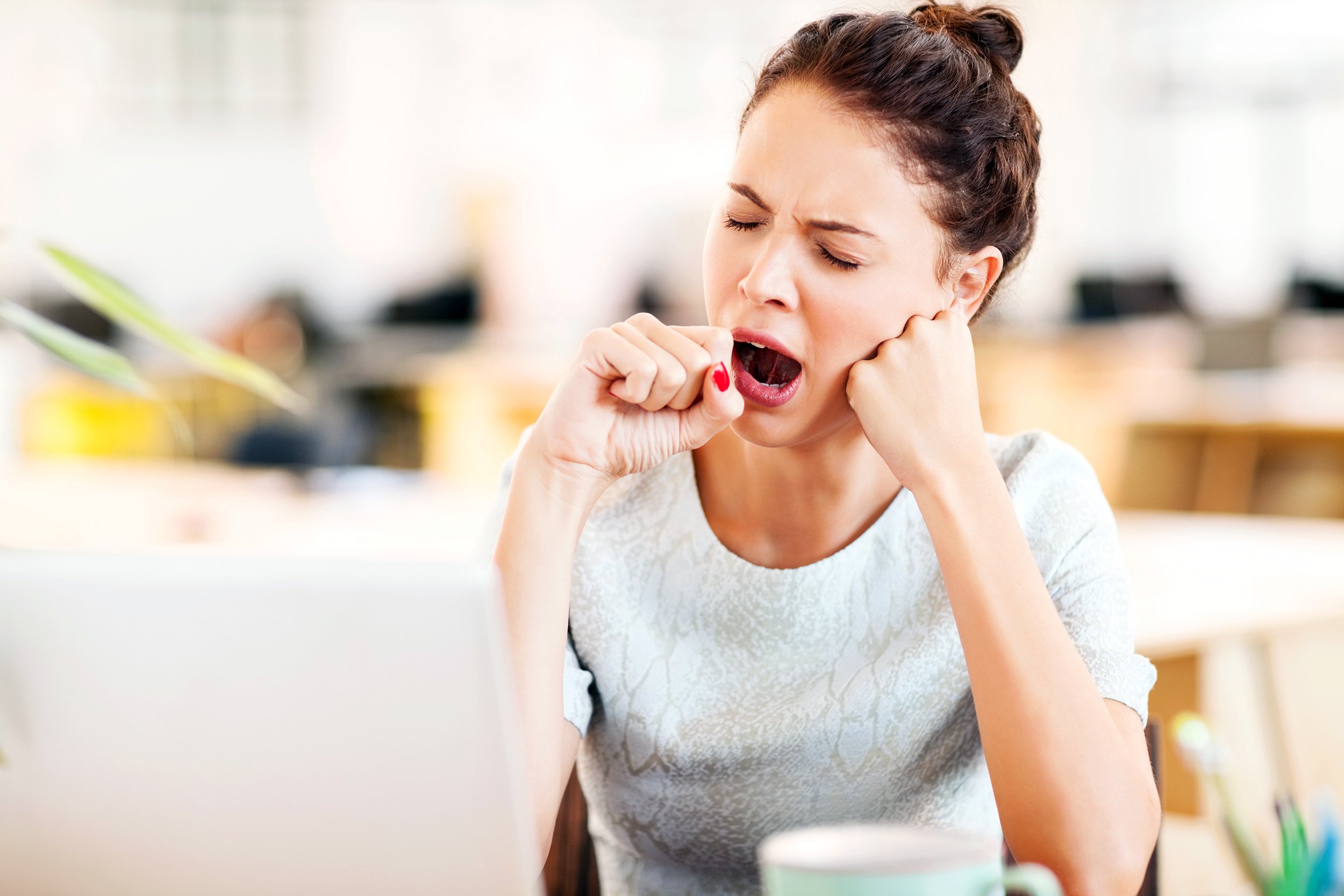 Woman yawning at work