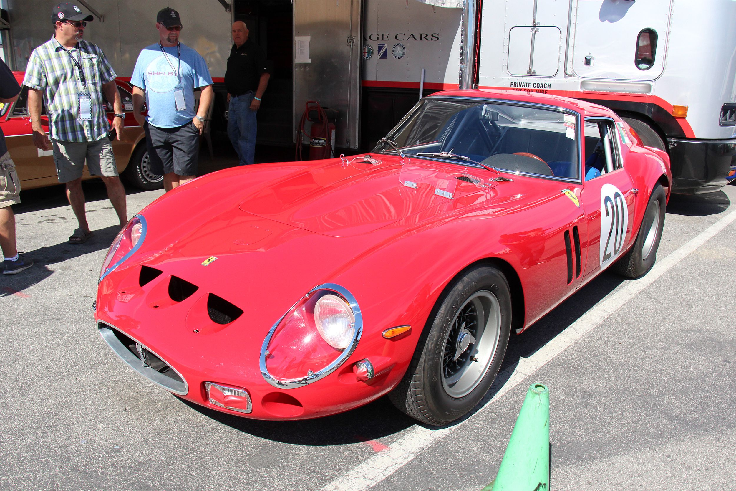 Two men looking at Red 1962-63 Ferrari 250 GTO Berlinetta
