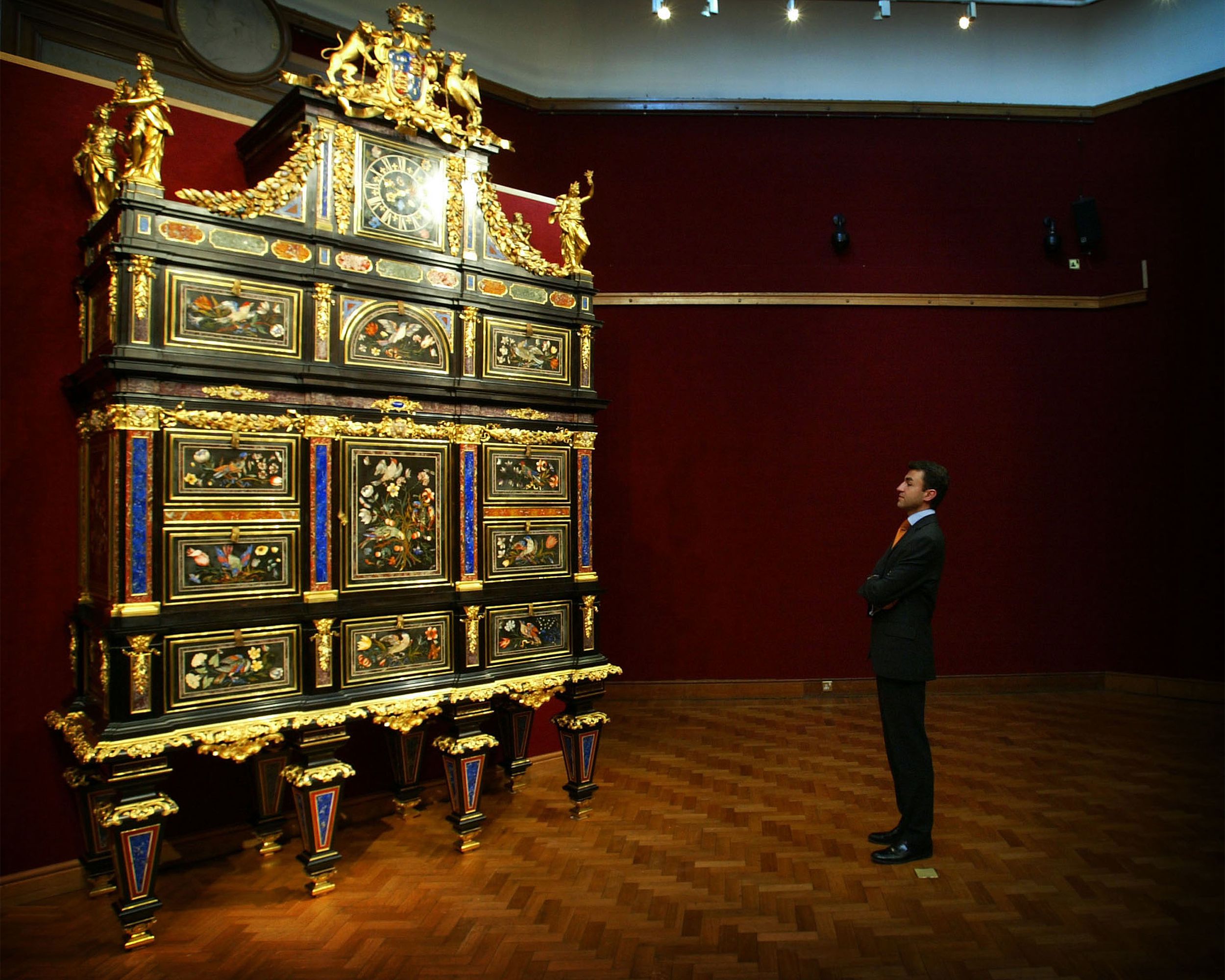 Man looking up at Badminton Cabinet