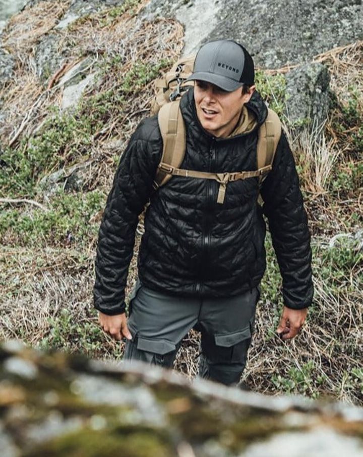 Man hiking in rainy forest in Beyond Clothing