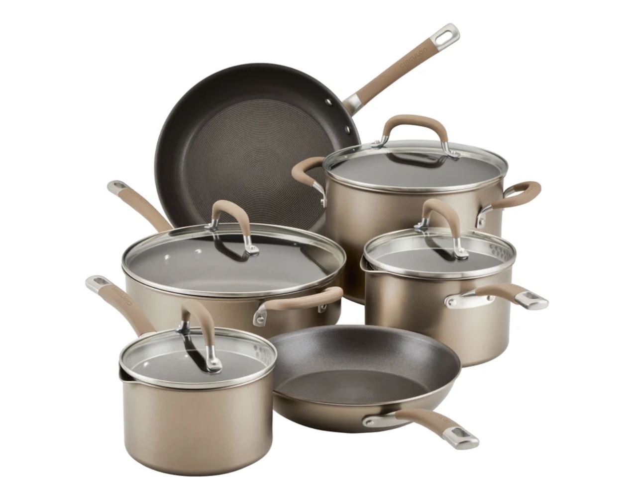 A set of six nonstick pots and pans with matching glass lids, featuring beige handles and a metallic finish—one of the best Costco finds—arranged together on a white background.