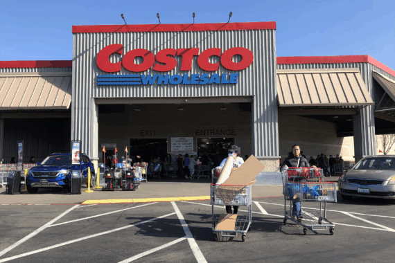 Costco customers push shopping carts through the parking lot of a Costco store on March 13, 2020 in Richmond, California.