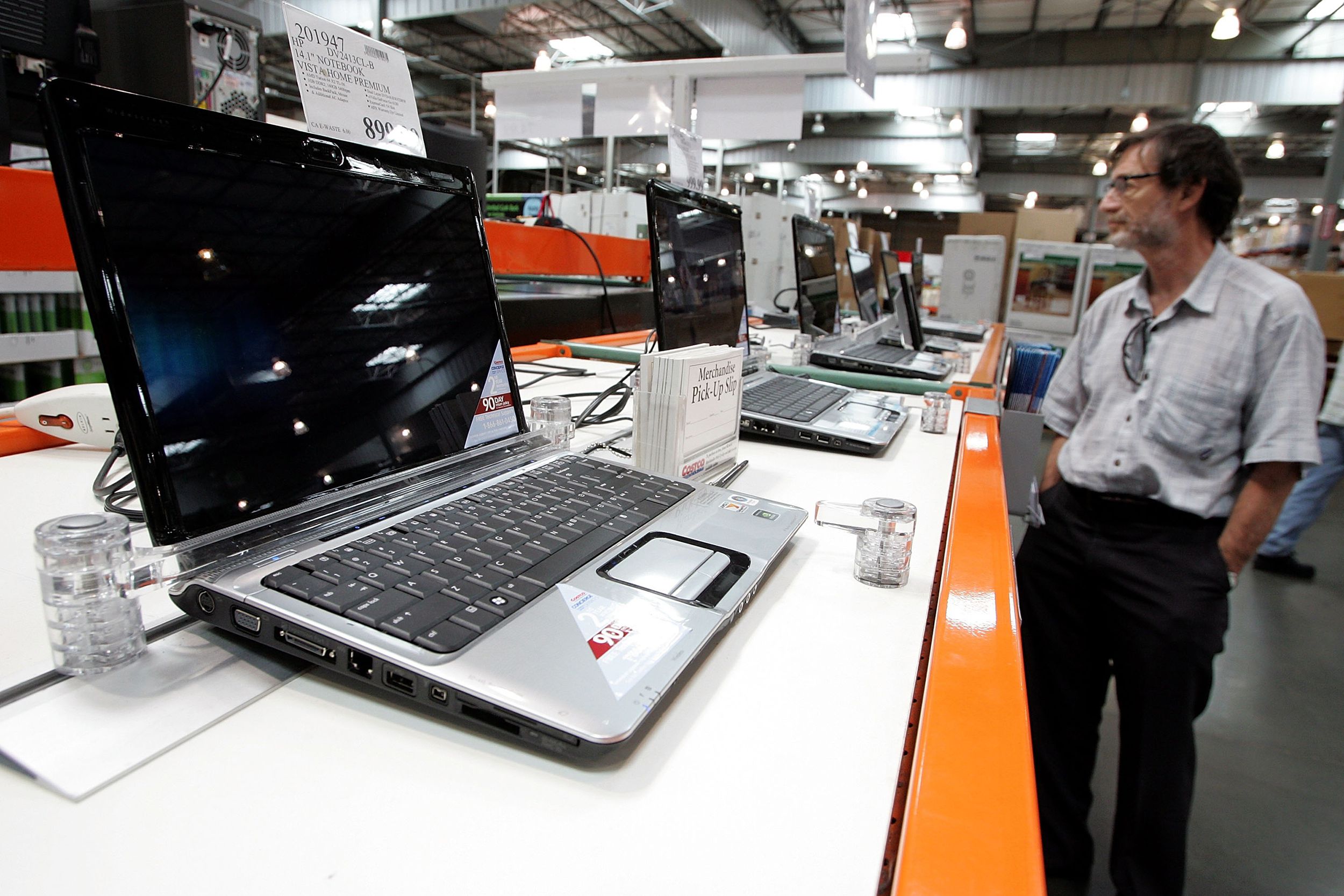 customer looks at a display of laptop computers at a Costco warehouse store July 13, 2007 in Richmond, California