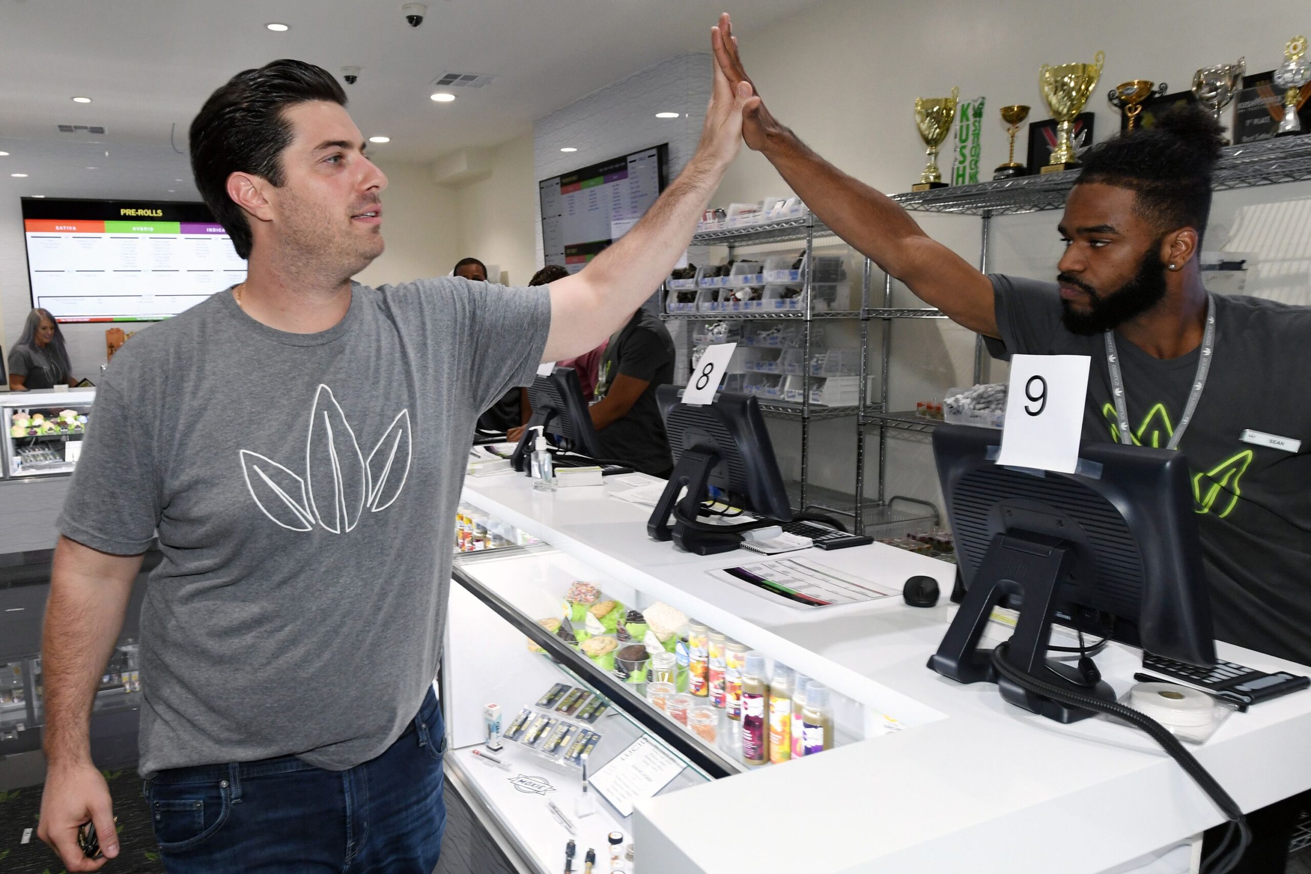 essence vegas ceo armen yemenidjian (l) high-fives employees at essence vegas cannabis dispensary as they get ready for the midnight start of recreational marijuana sales on june 30, 2017 in las vegas, nevada