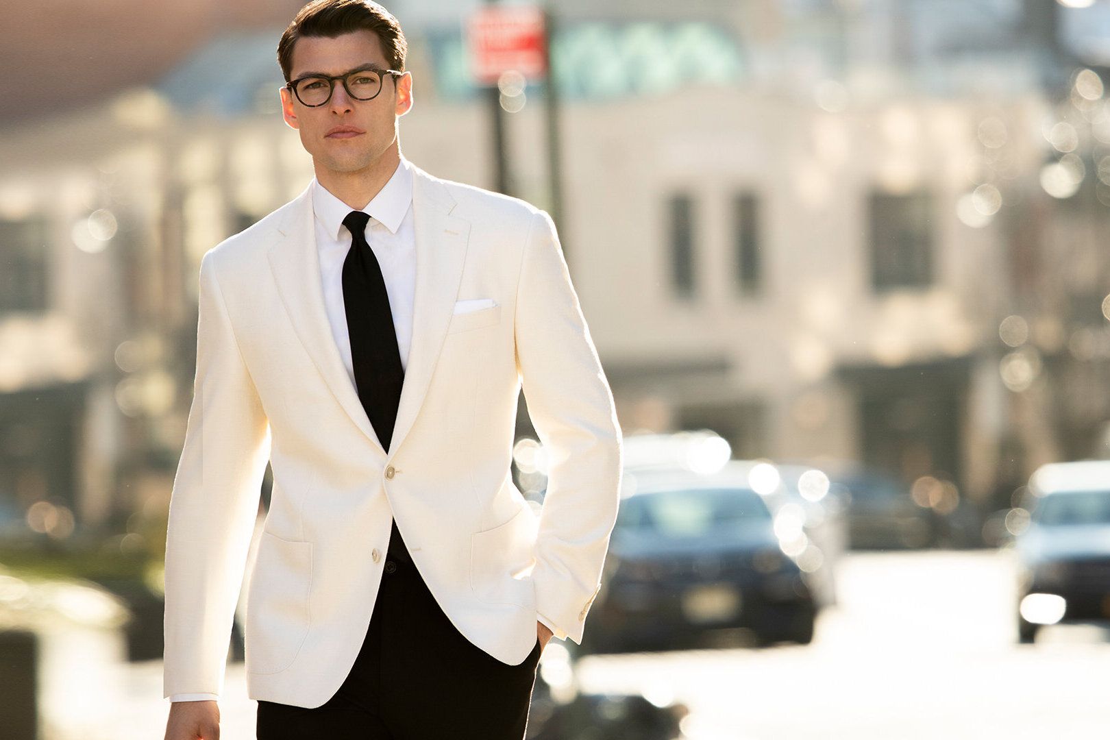 Young man modeling white jacket and black tie by Hart Schaffner Marx