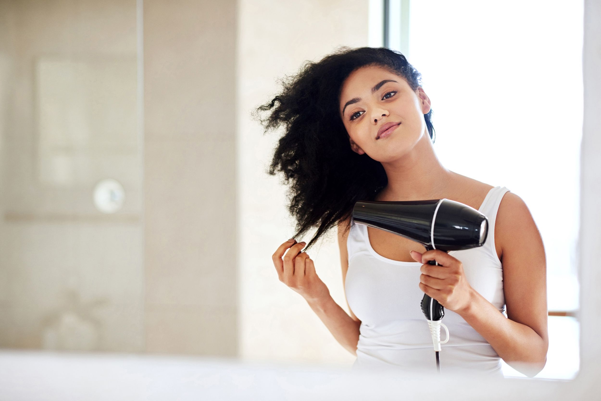 Woman blow drying her hair
