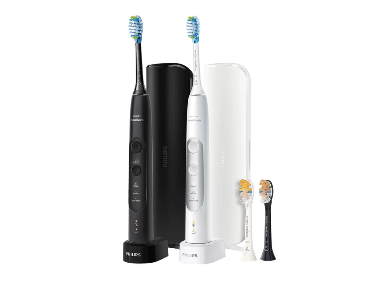 Two electric toothbrushes—one black, one white—each with a matching travel case, charging base, and extra brush heads. The set stands upright and ready to use, making it one of the best Costco finds for your oral care routine.