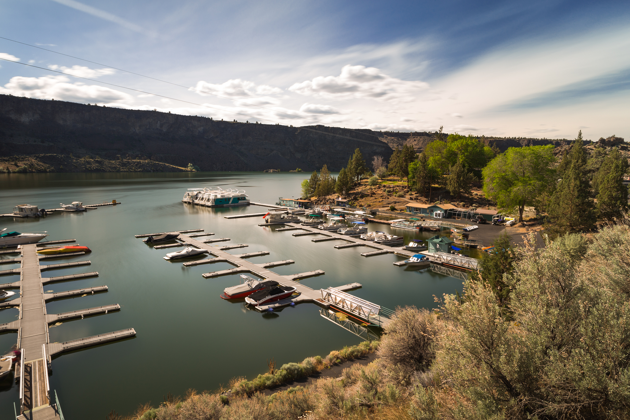 Piers on Lake Billy Chinook, Oregon, about half opened and half with boats, expansive view, on a sunny day during late summer