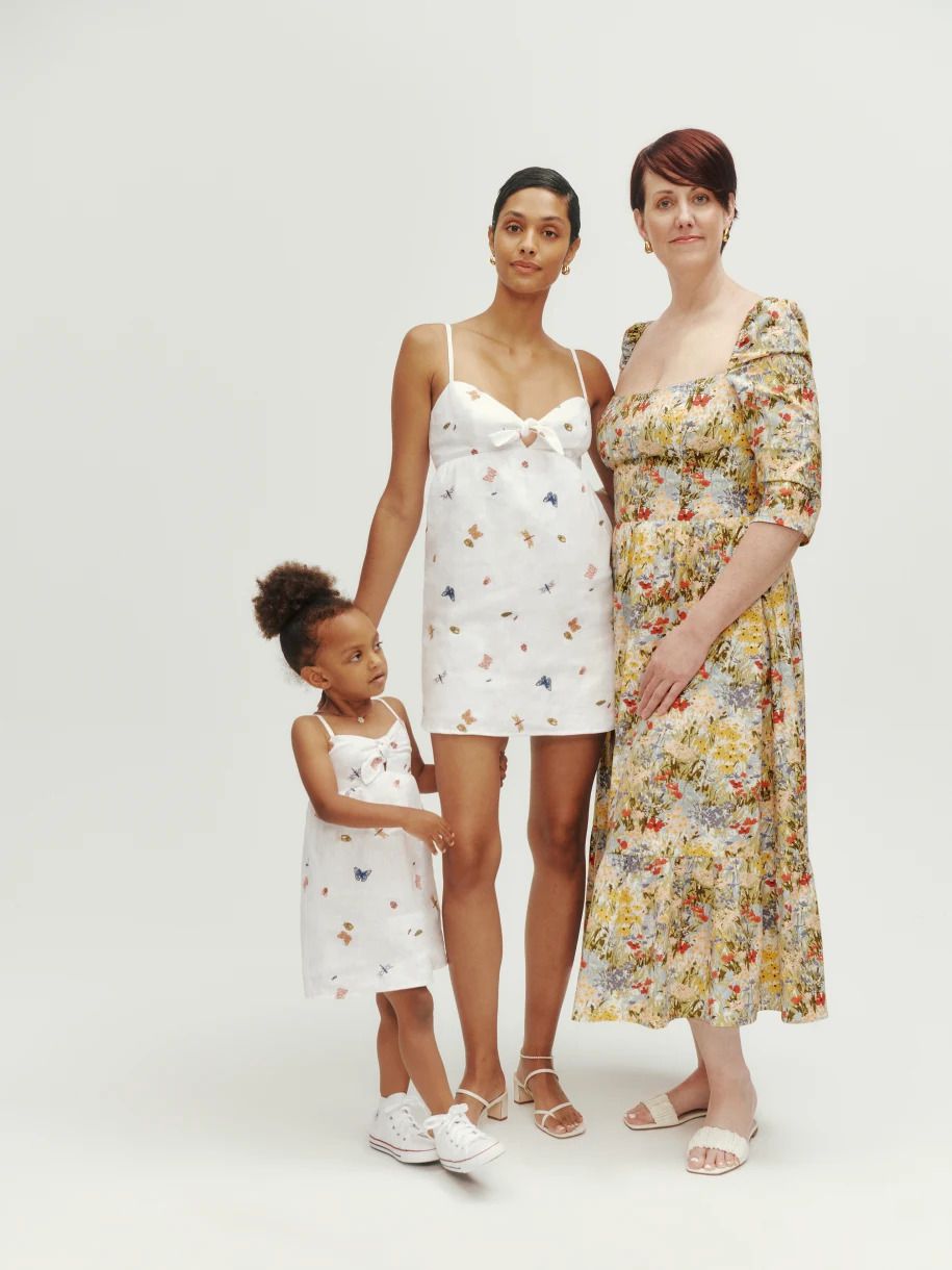 Two women and a young girl modeling dresses from Reformation