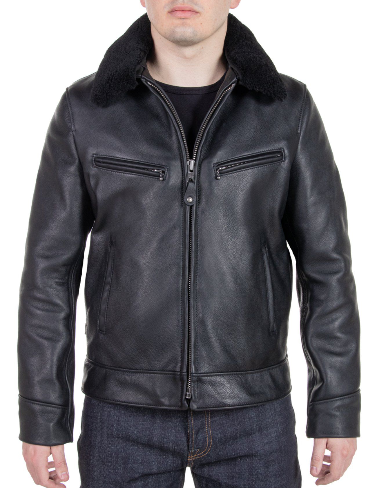 Male model wearing Schott NYC zippered black leather jacket and dark denim jeans