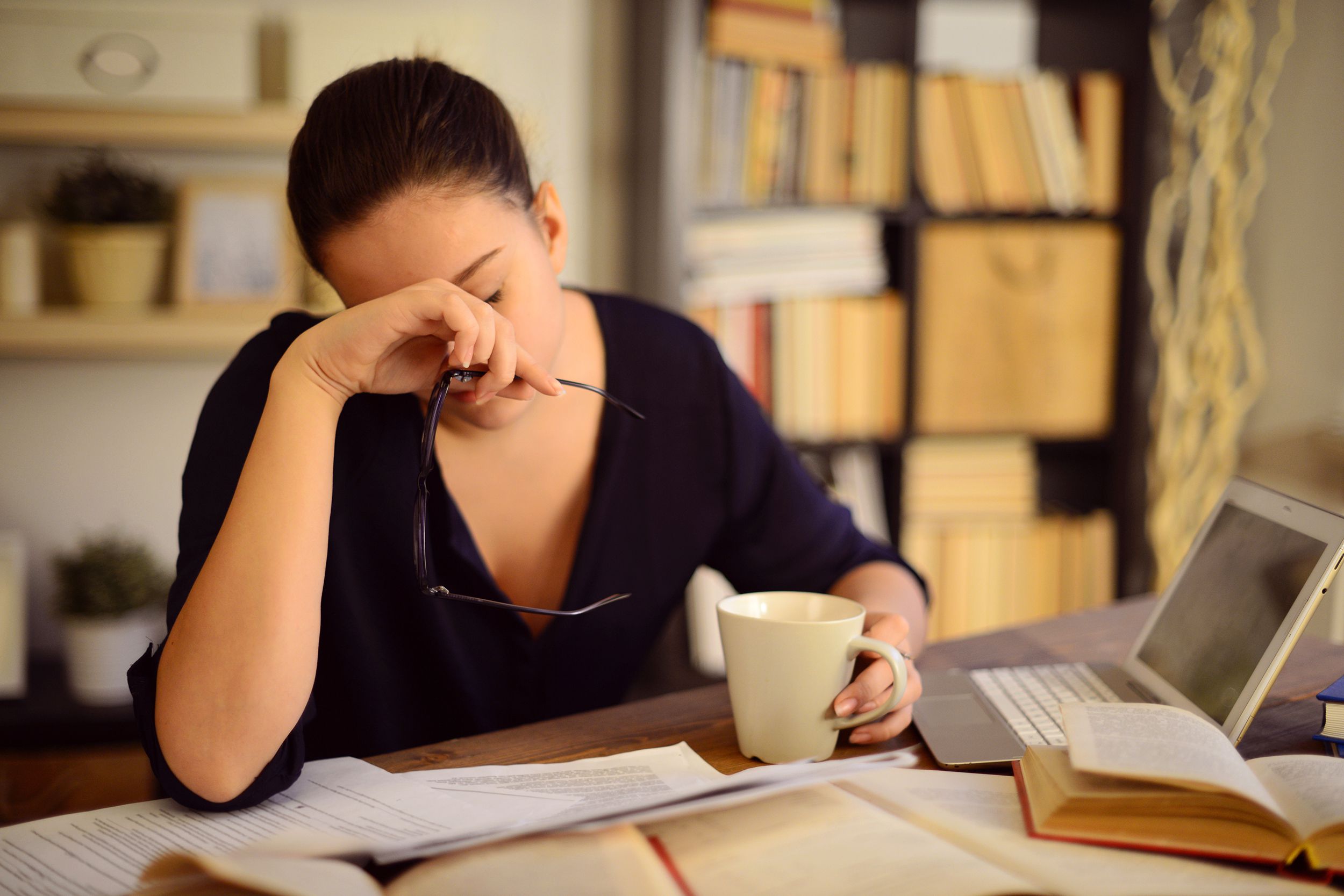 Woman working at her desk with a headache