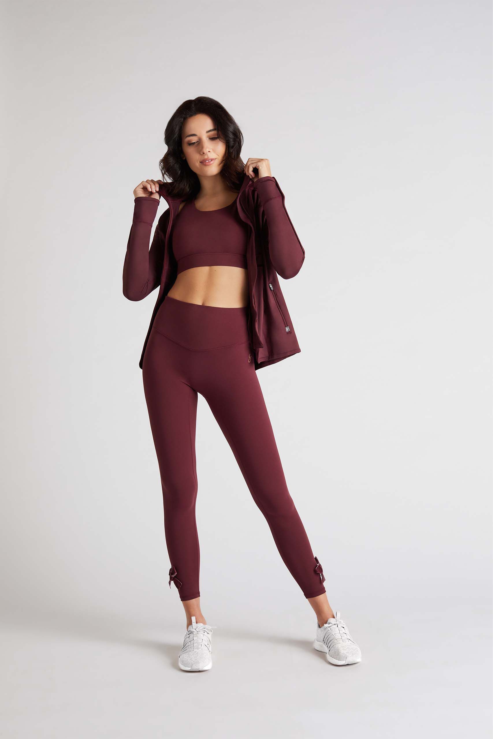 Woman modeling burgundy sportswear by SportPort