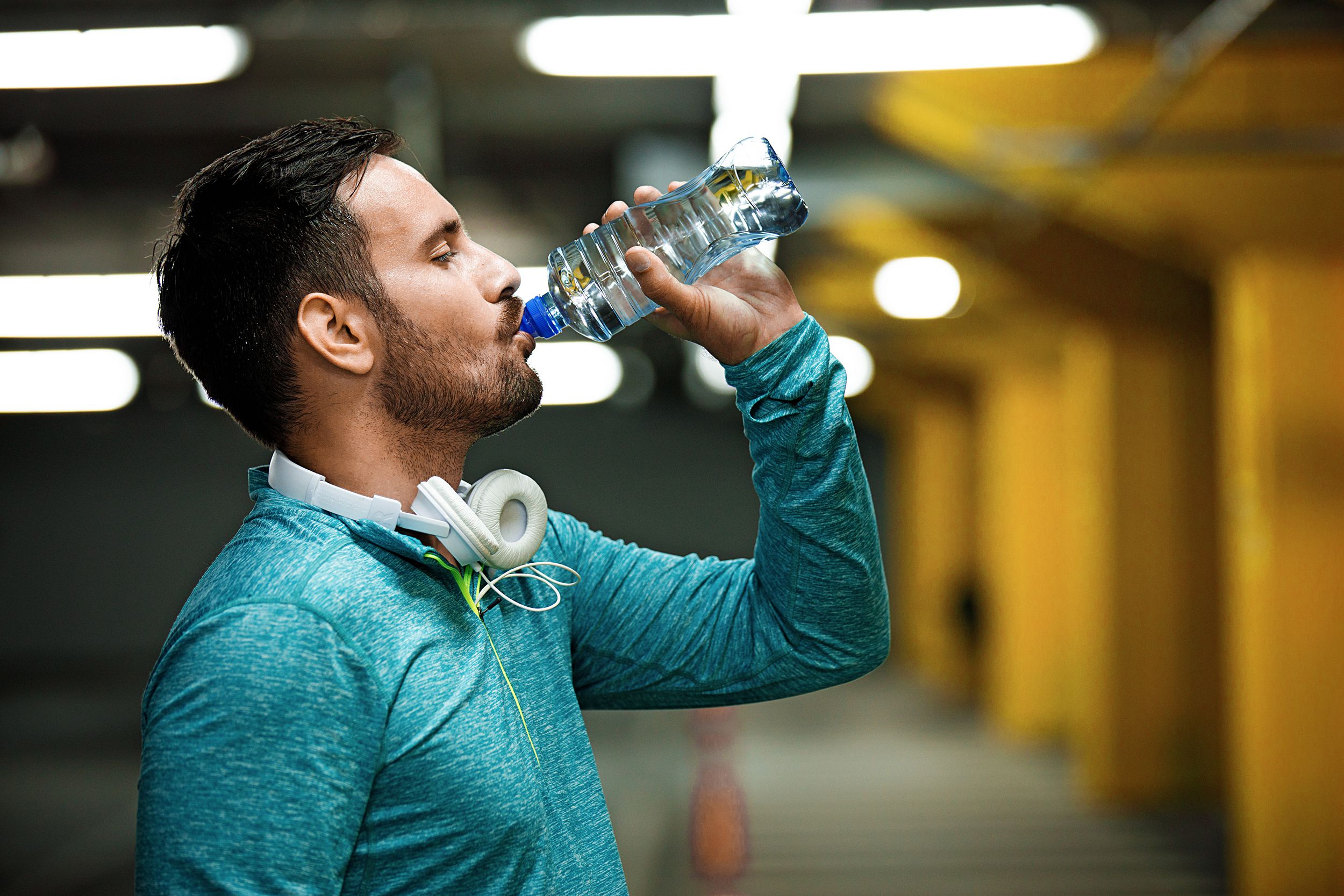 Athletic man drinking water during a workout