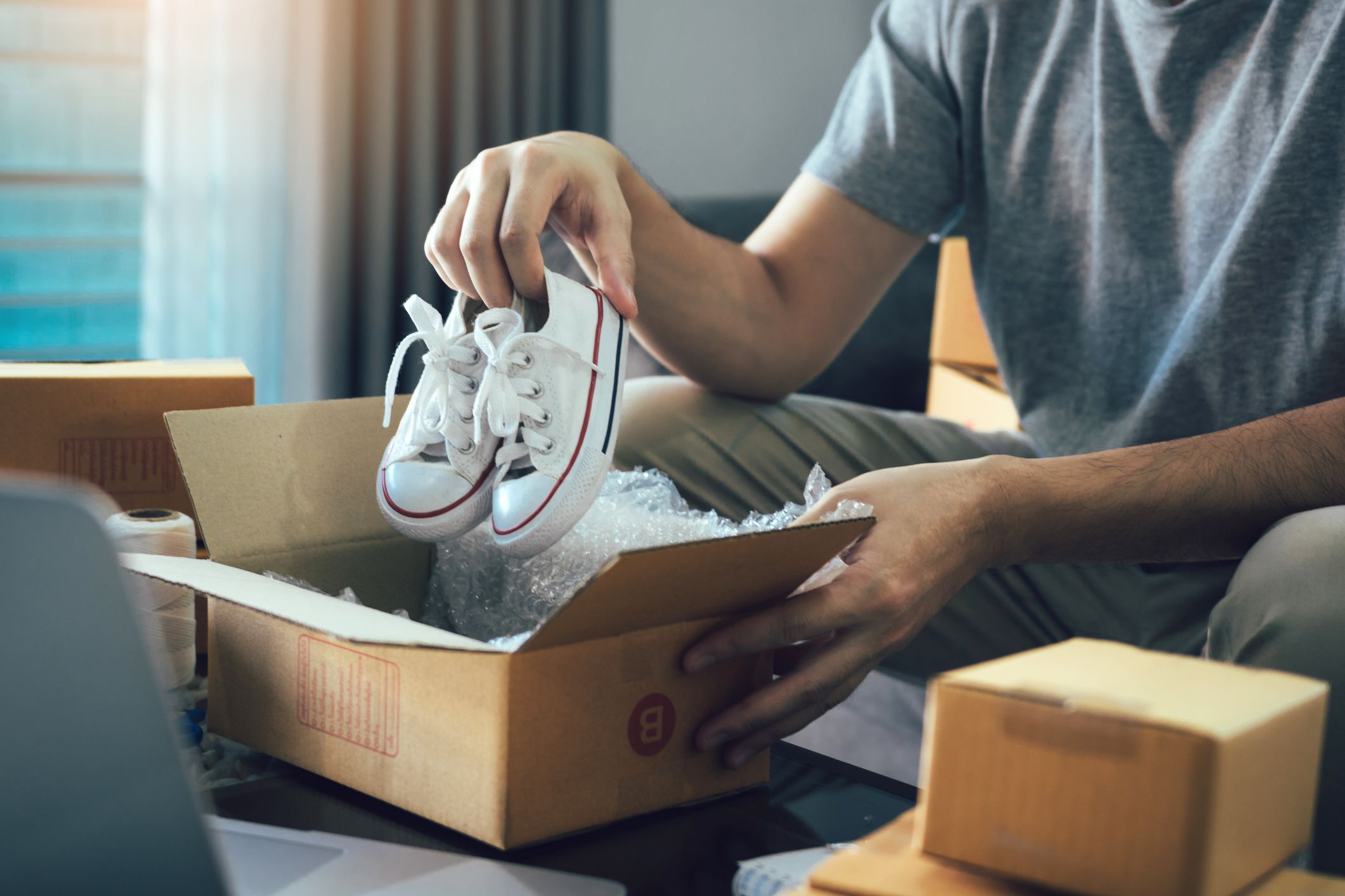man holding baby shoes