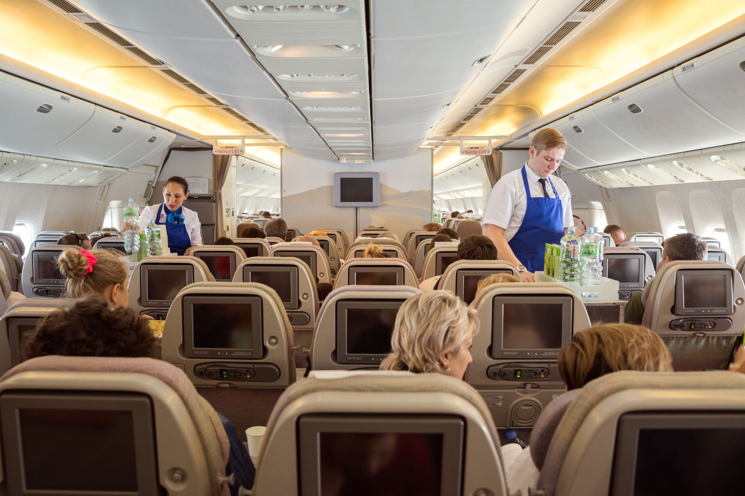 Flight St. Petersburg - Bourgas - June 24, 2019: Steward and stewardess Iraero airlines serve passengers on a charter flight, offering soft drinks