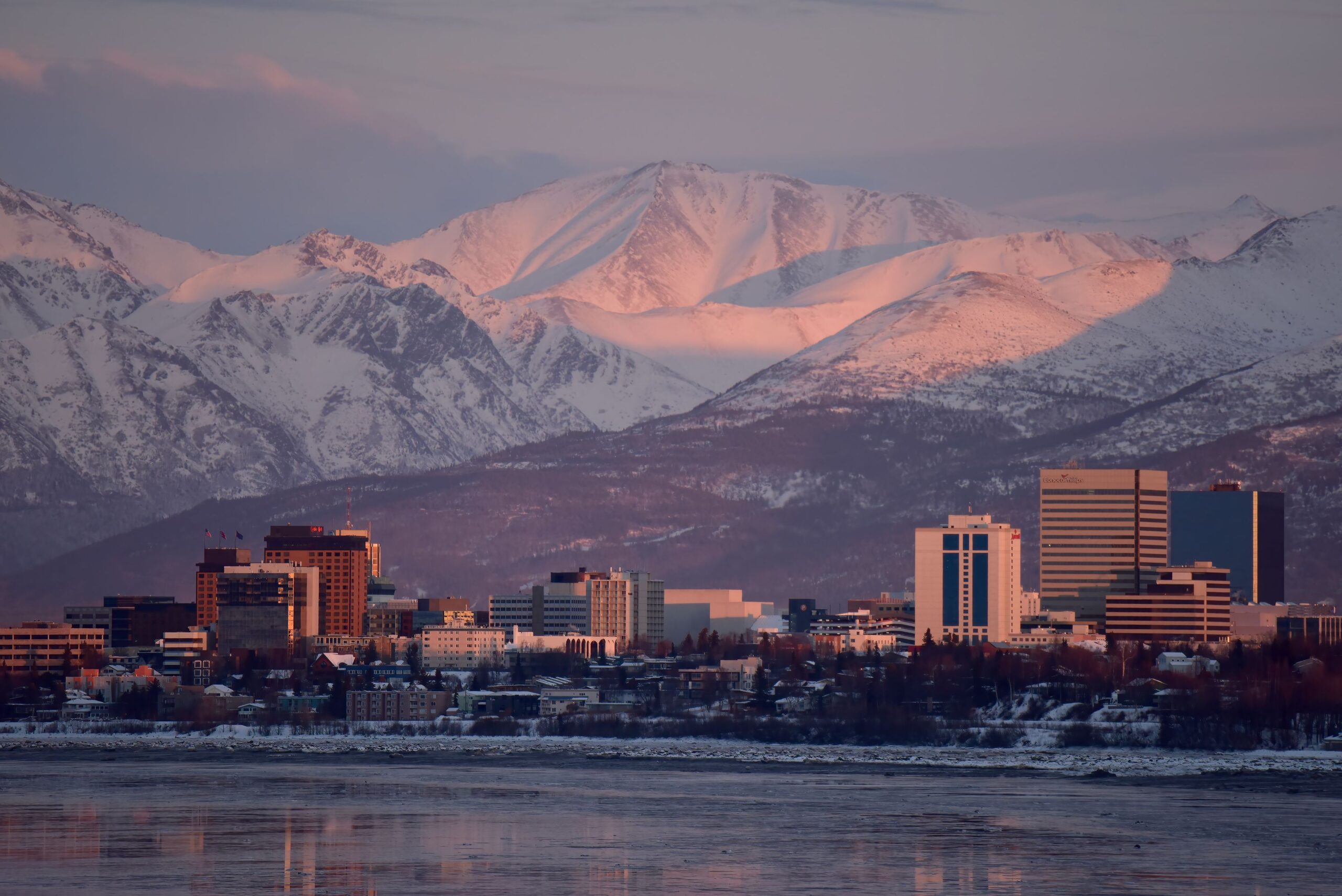 The setting sun paints Anchorage, Alaska, a pastel pink in a phenomenon called alpenglow.