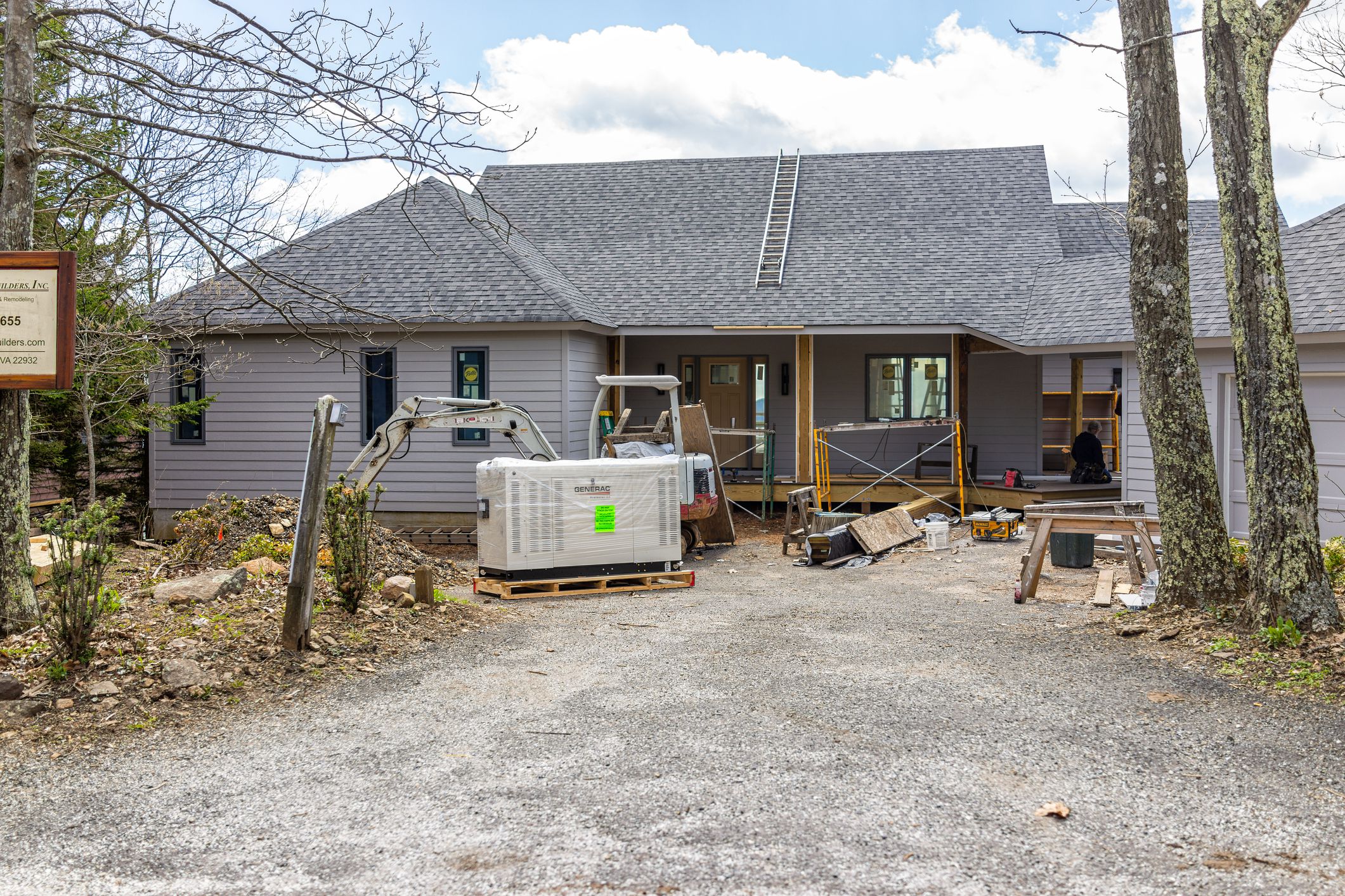 Wintergreen Resort, USA - April 16, 2021: Single family mountain house with construction site for renovation repair works, generac electricity generator, excavator ski resort town of Virginia