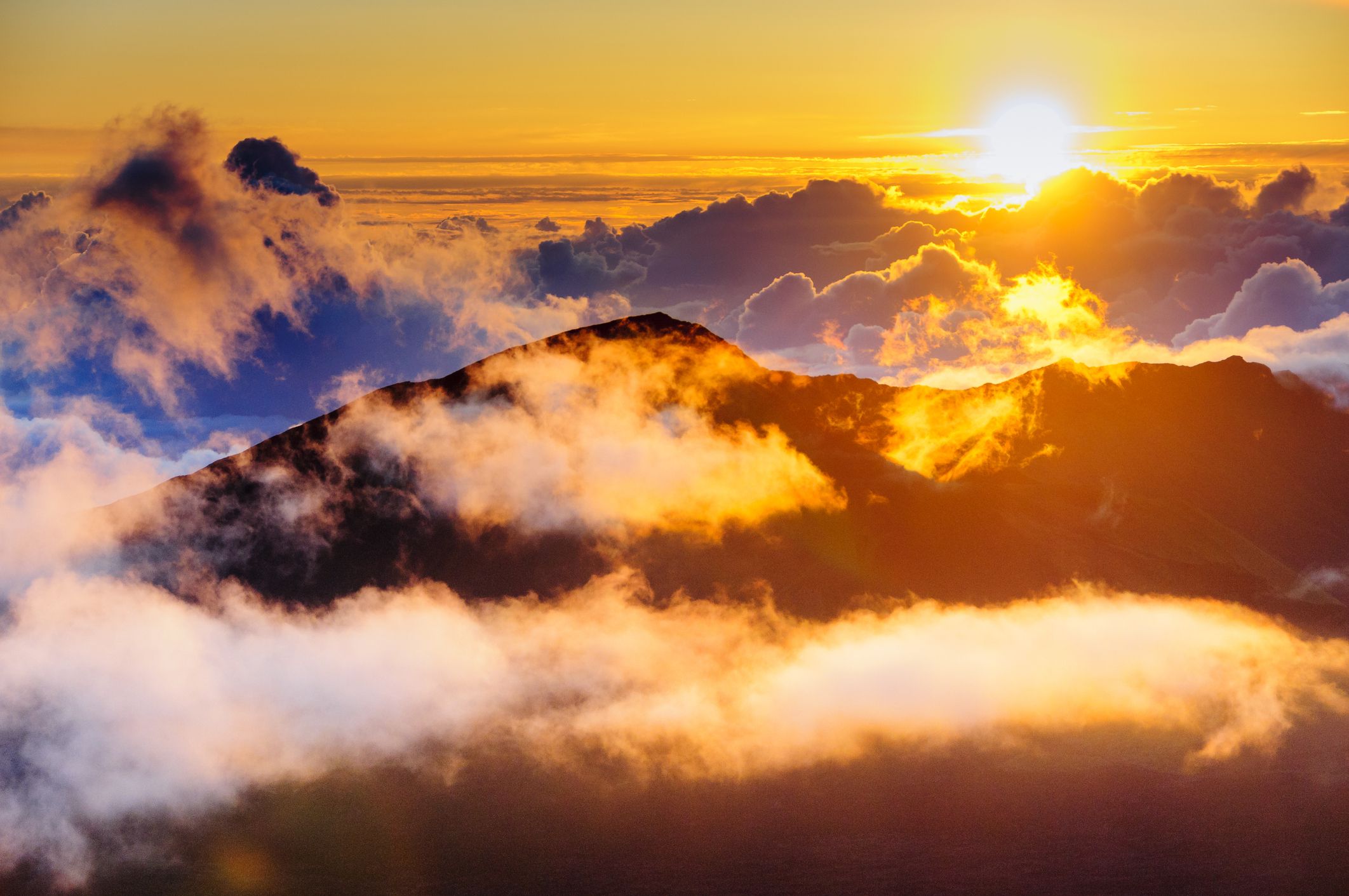 People watching clouds at sunrise from the top of Haleakala Crater on Maui, Hawaii, USA