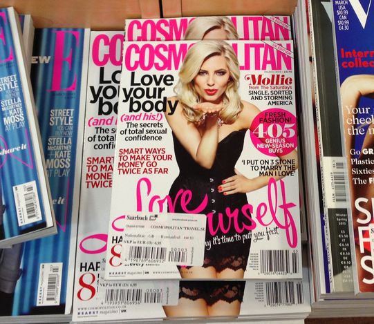 Popular british magazines in english language displayed inside a newsstand on the central station(Cologne,Germany)