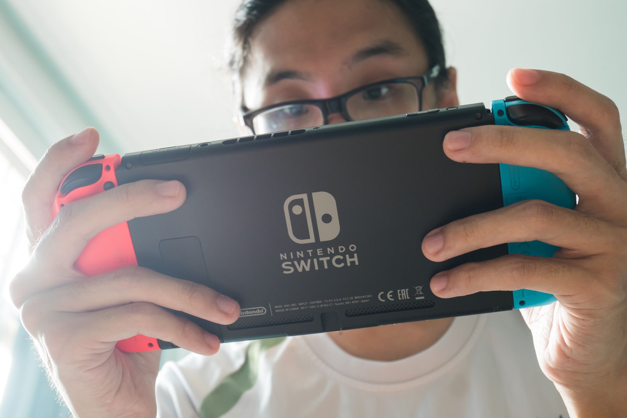 Bangkok, Thailand - October 31, 2017 : A man playing Nintendo Switch.