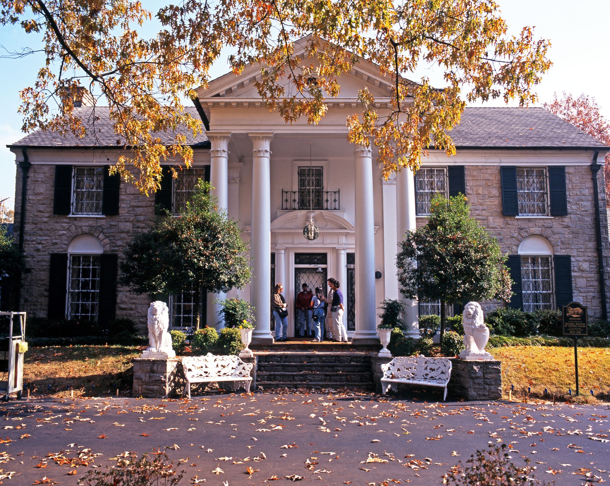 Front view of Graceland, the home of Elvis Presley with tourists enjoying the setting, during the Autumn, Memphis, Tennessee, United States of America.