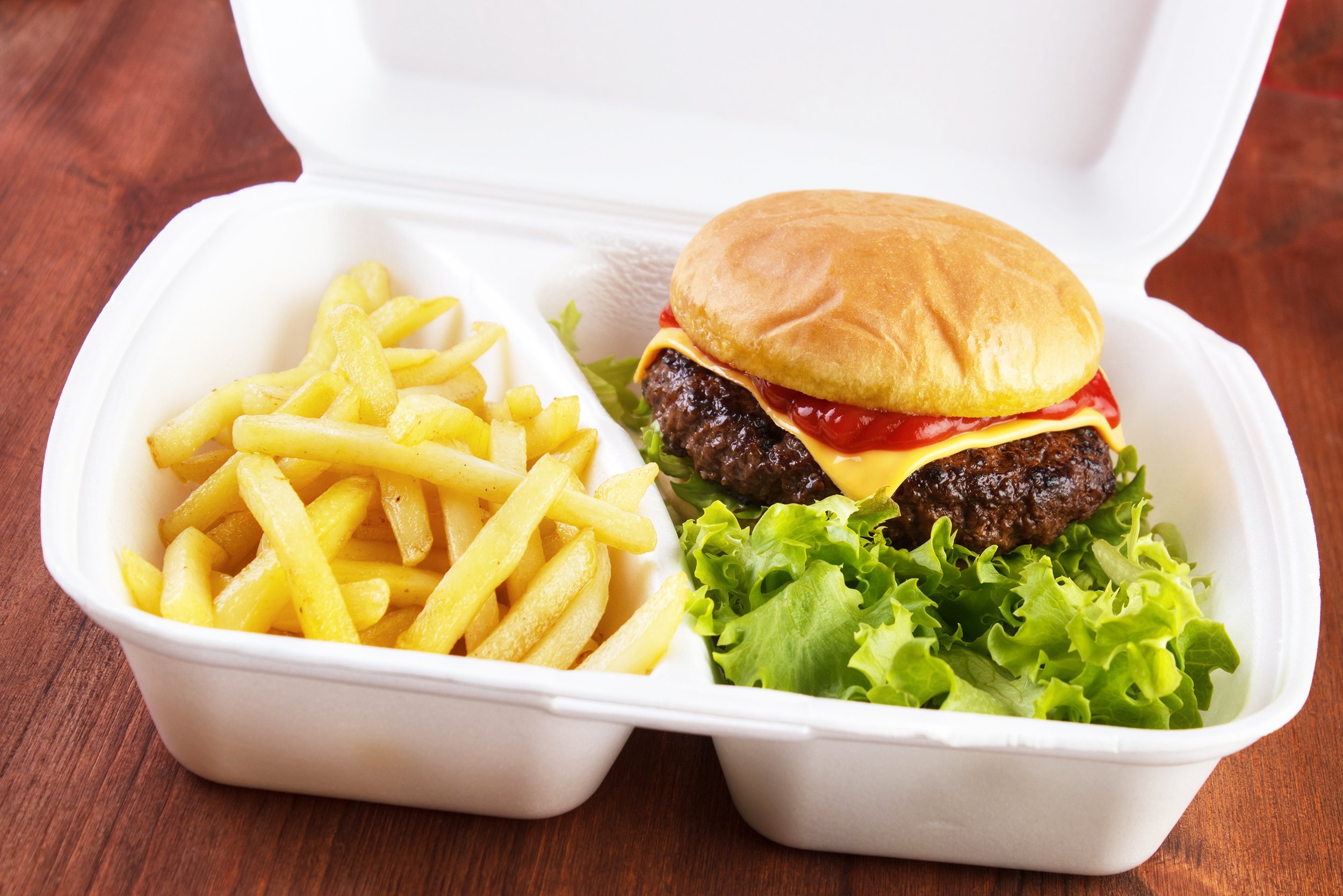 burger and fries portion in takeout food box