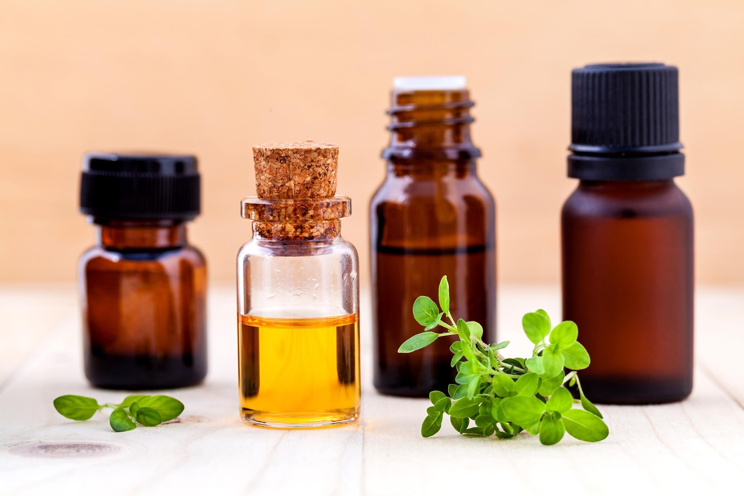bottles of essential oils on wooden table