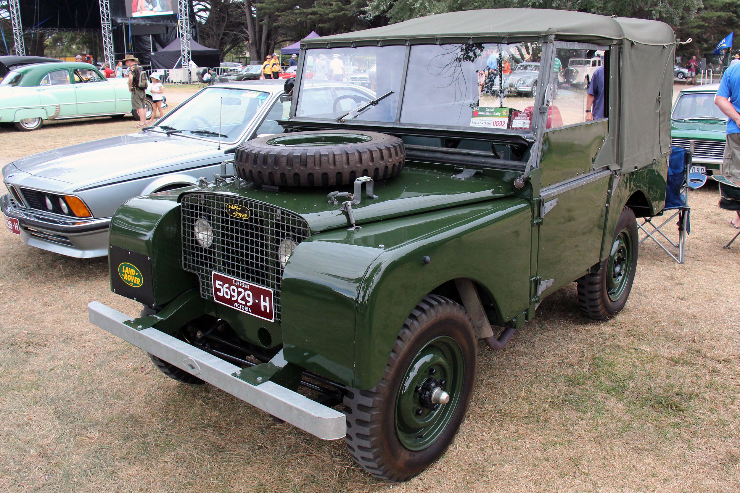 Dark green 1948 Land Rover Series I parked on a grass field