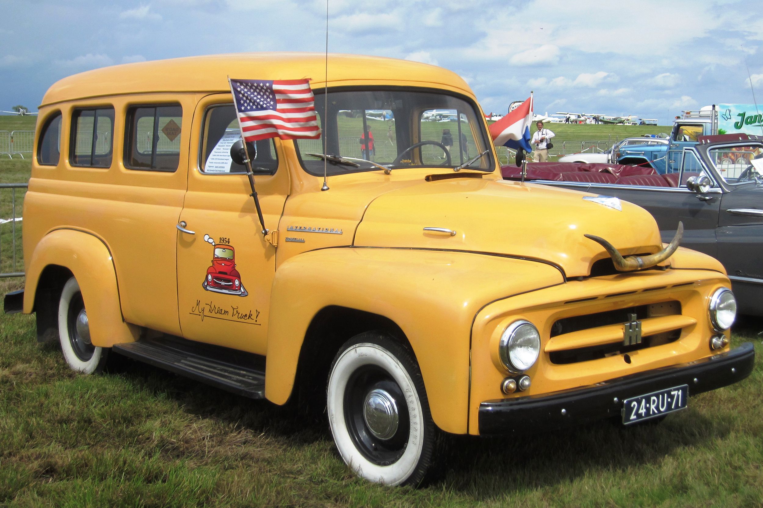 1956 International Harvester Travelall on a cloudy day parked on grass