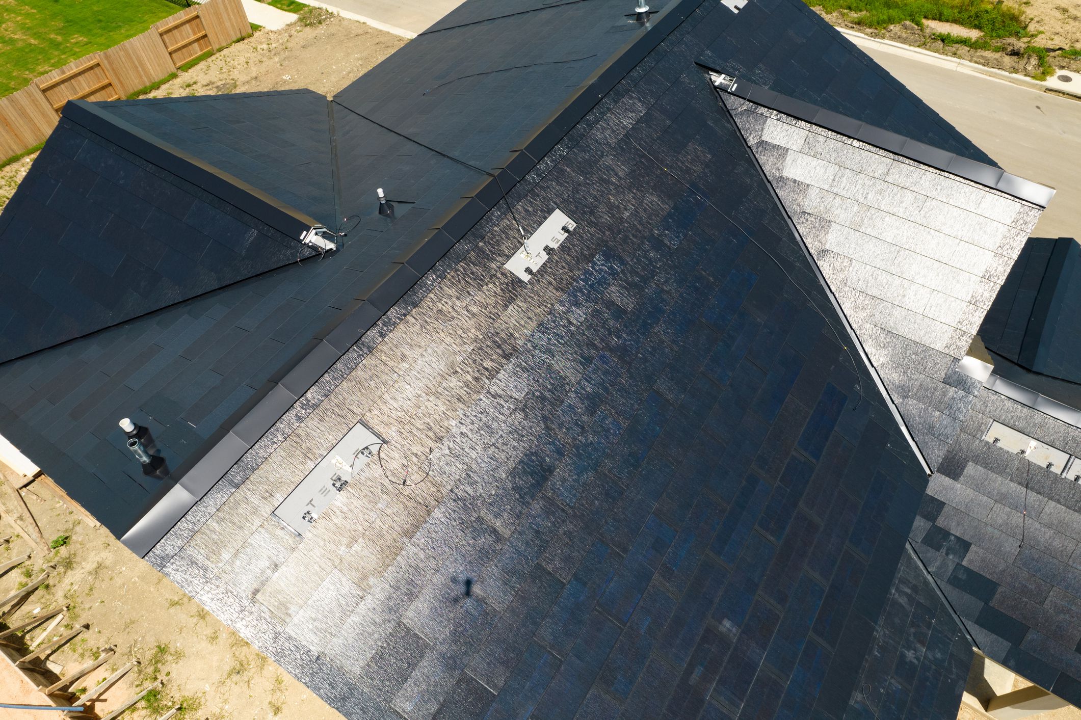 Aerial of Tesla Solar Roof Tiles on home being newly built in new subdivision in Austin, Texas