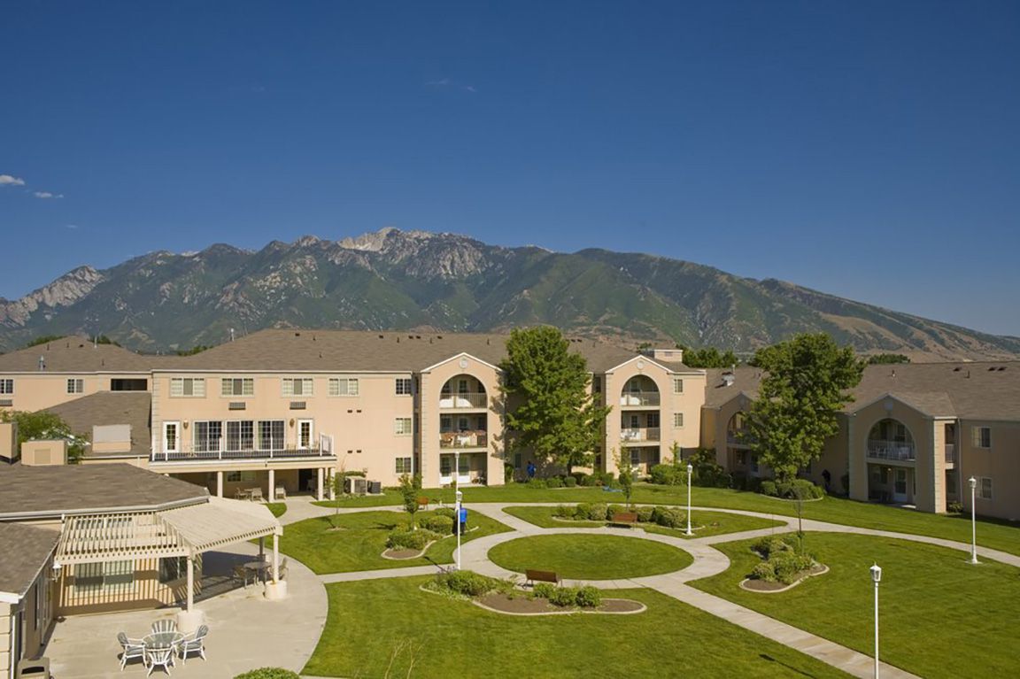 Cedarwood at Sandy exterior with mountains in background on sunny clear day