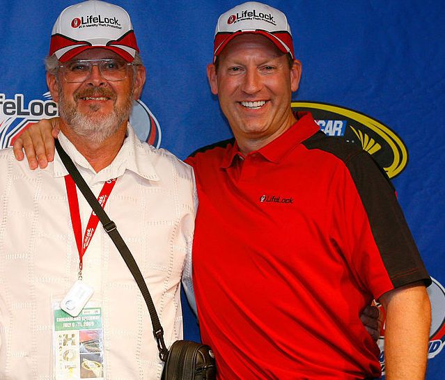 Todd Davis, CEO of LifeLock (R), poses with million dollar contest winners Donna (L) and Richard Musgrave (C) after the NASCAR Sprint Cup Series LifeLock.com 400 at Chicagoland Speedway on July 11, 2009 in Joliet, Illinois.
