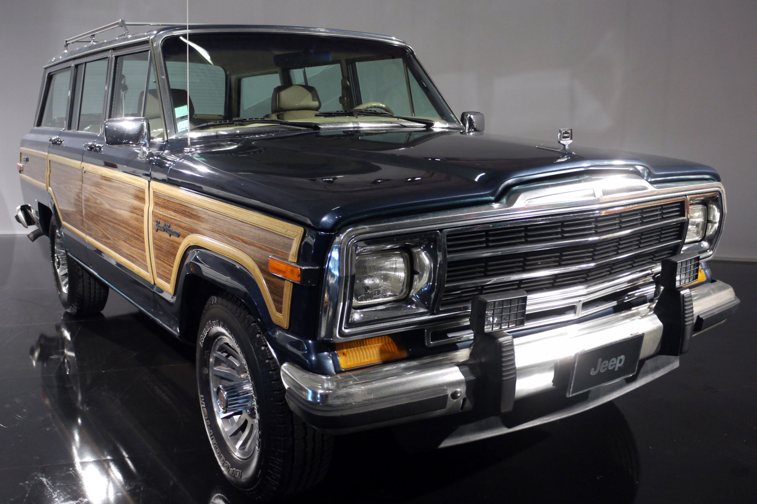 Jeep Grand Wagoneer full-size black with wood paneling.