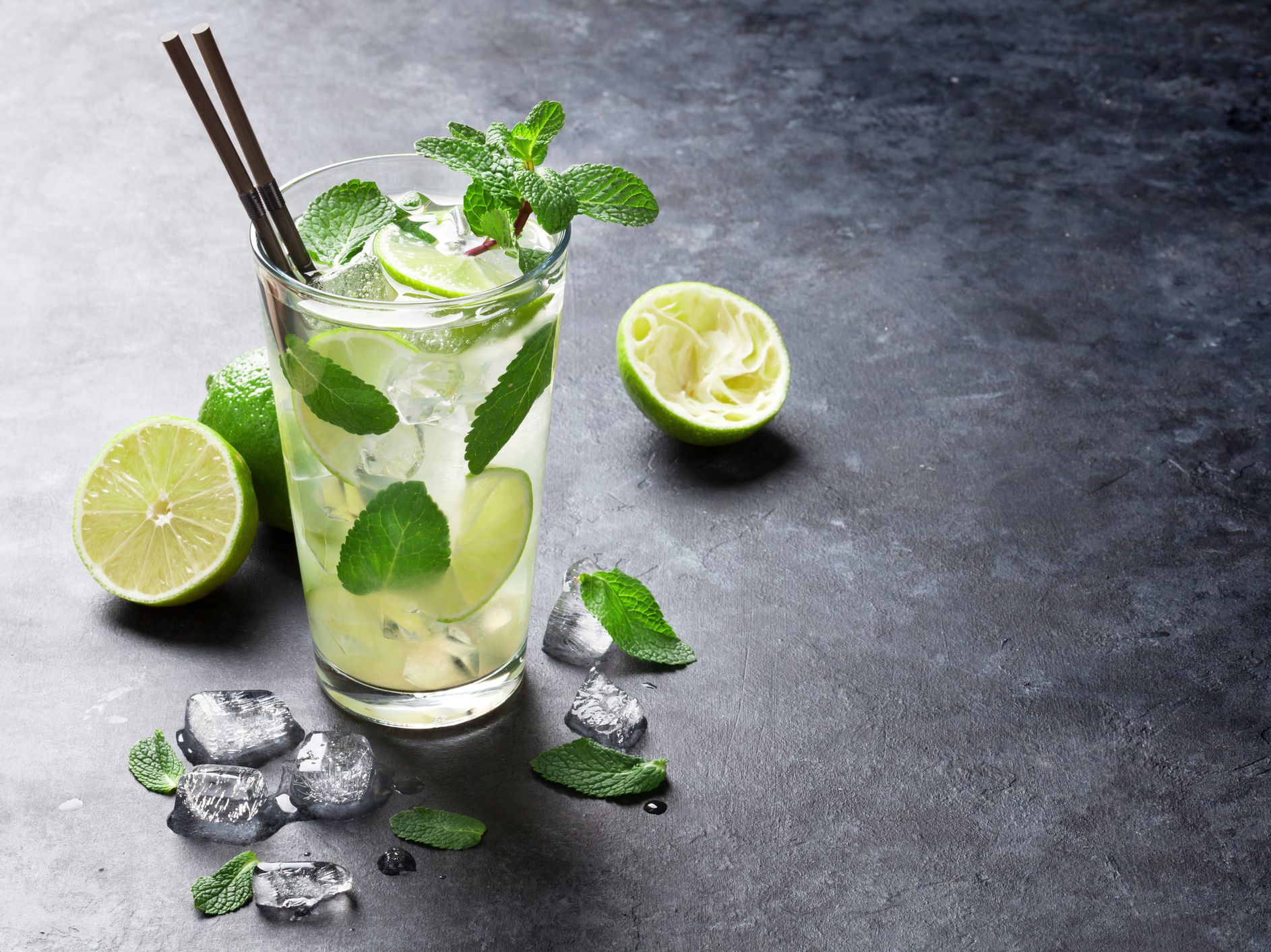 Mojito cocktail on dark stone table.