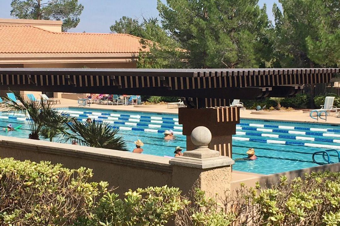 People in sun hats standing in Sun City Summerlin pool