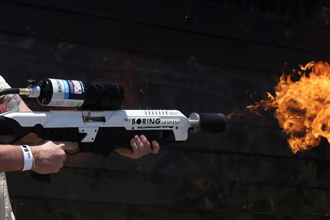 Man using a The Boring Company Not-a-Flamethrower, it is spitting out a flame
