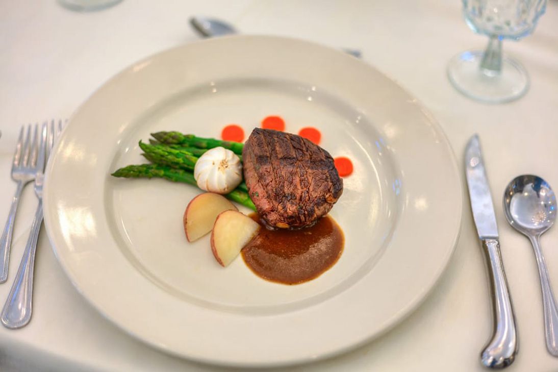 Off white large plate with steak and asparagus at The Forum at Park Lane