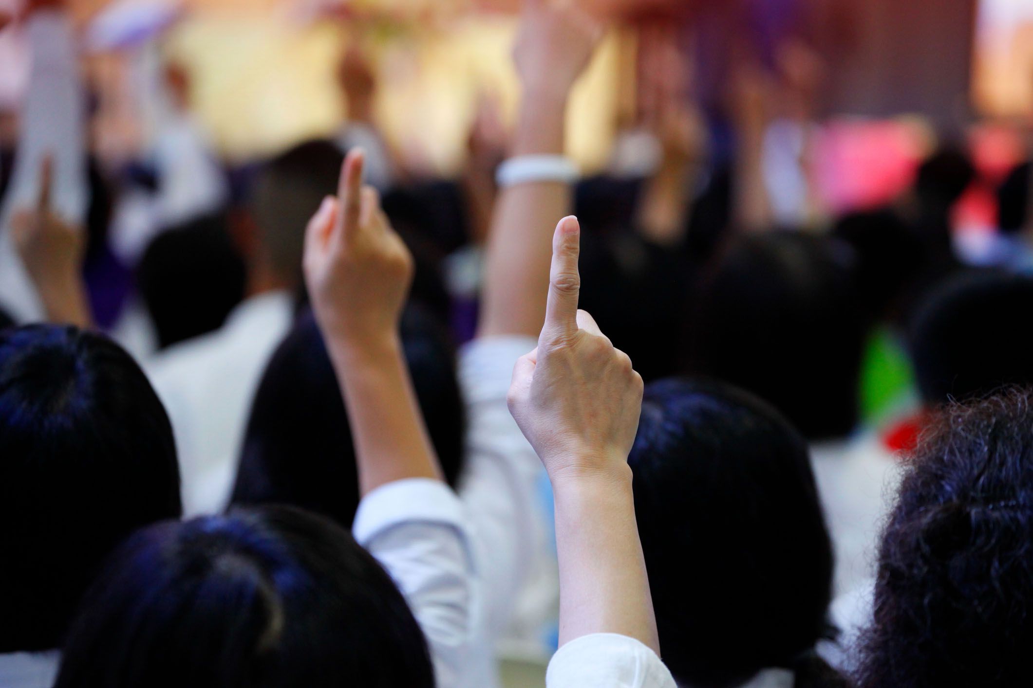 hands up to bid at auction