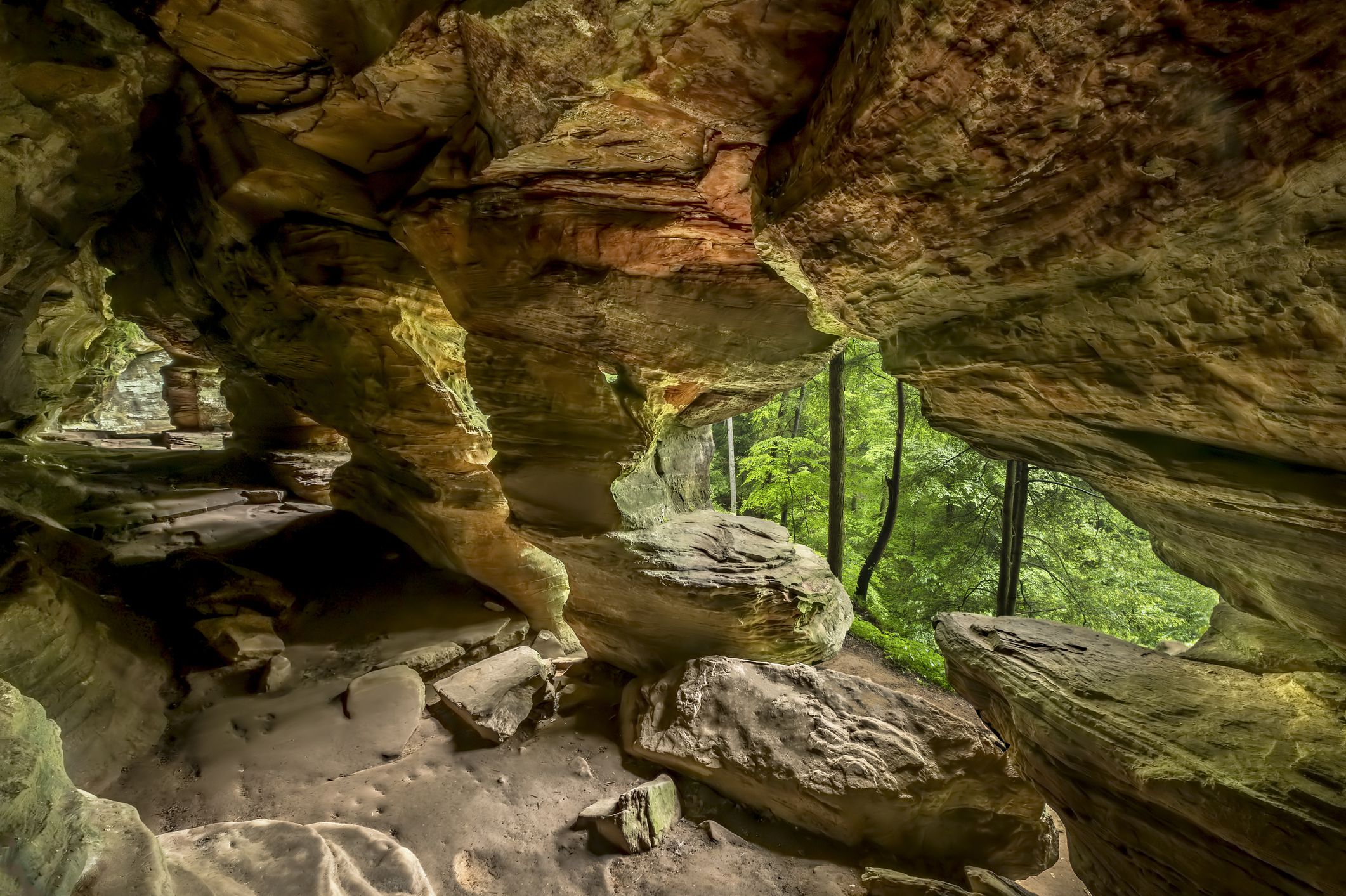 In Hocking Hills State Park, Ohio, Rock House is a twenty-five foot tall cave, on the side of a tall sandstone cliff, with seven natural Gothic-arched windows lighting its two hundred foot length.