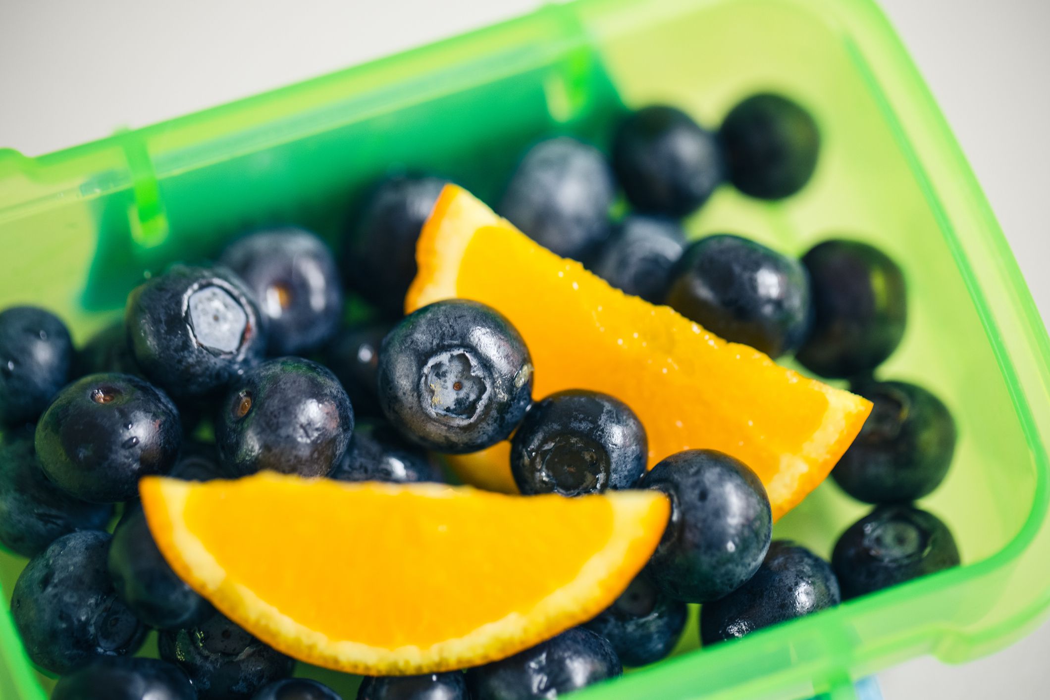 Polypropylene (PP) plastic container with blueberries and orange slices