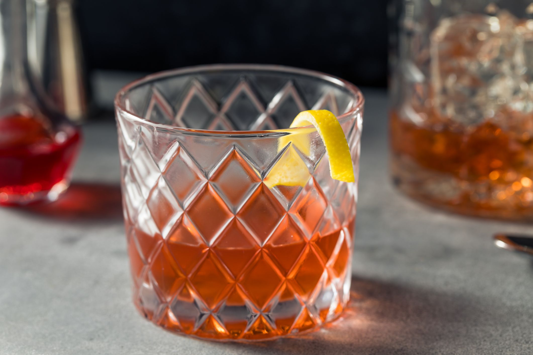 Boozy Refreshing Rye Whiskey Sazerac Cocktail with a Lemon Garnish