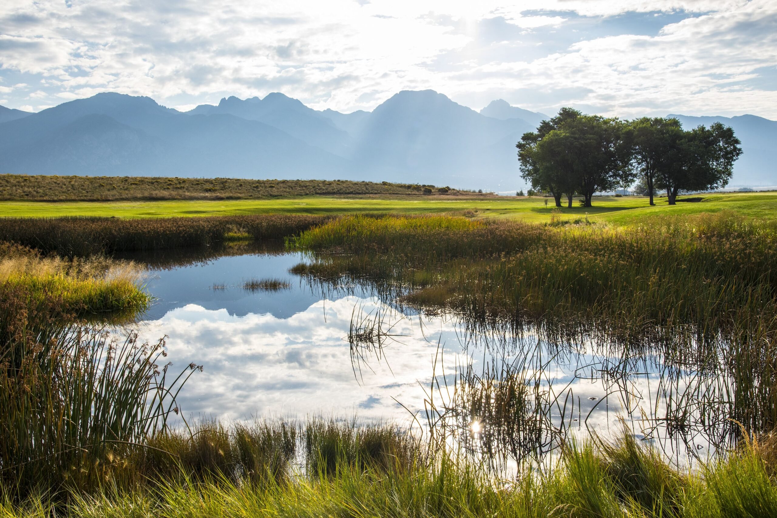Landscaped pond and grounds near Crestone, Colorado in the upper San Luis Valley. Rocky Mountains.