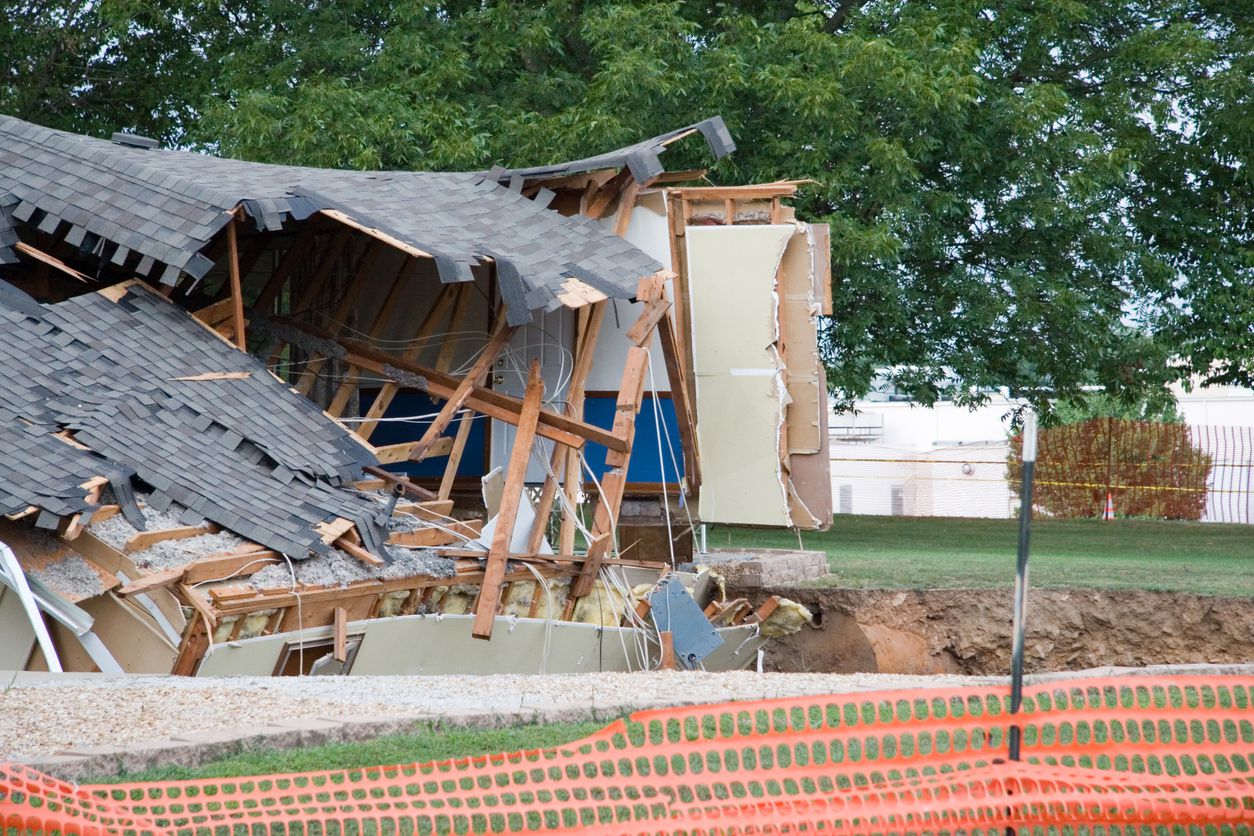 House falling into a sinkhole.