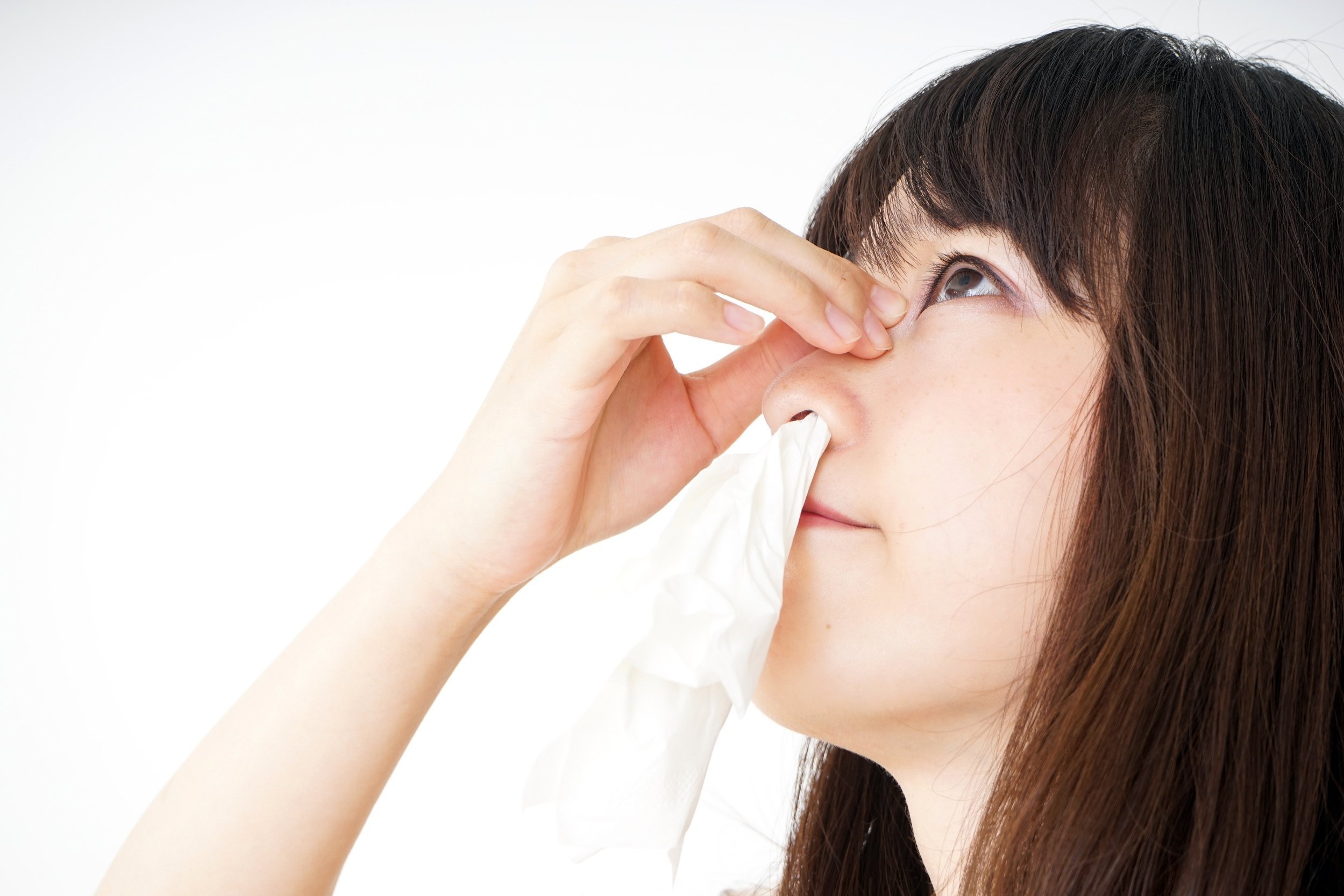 Young woman leaning back with a bloody nose