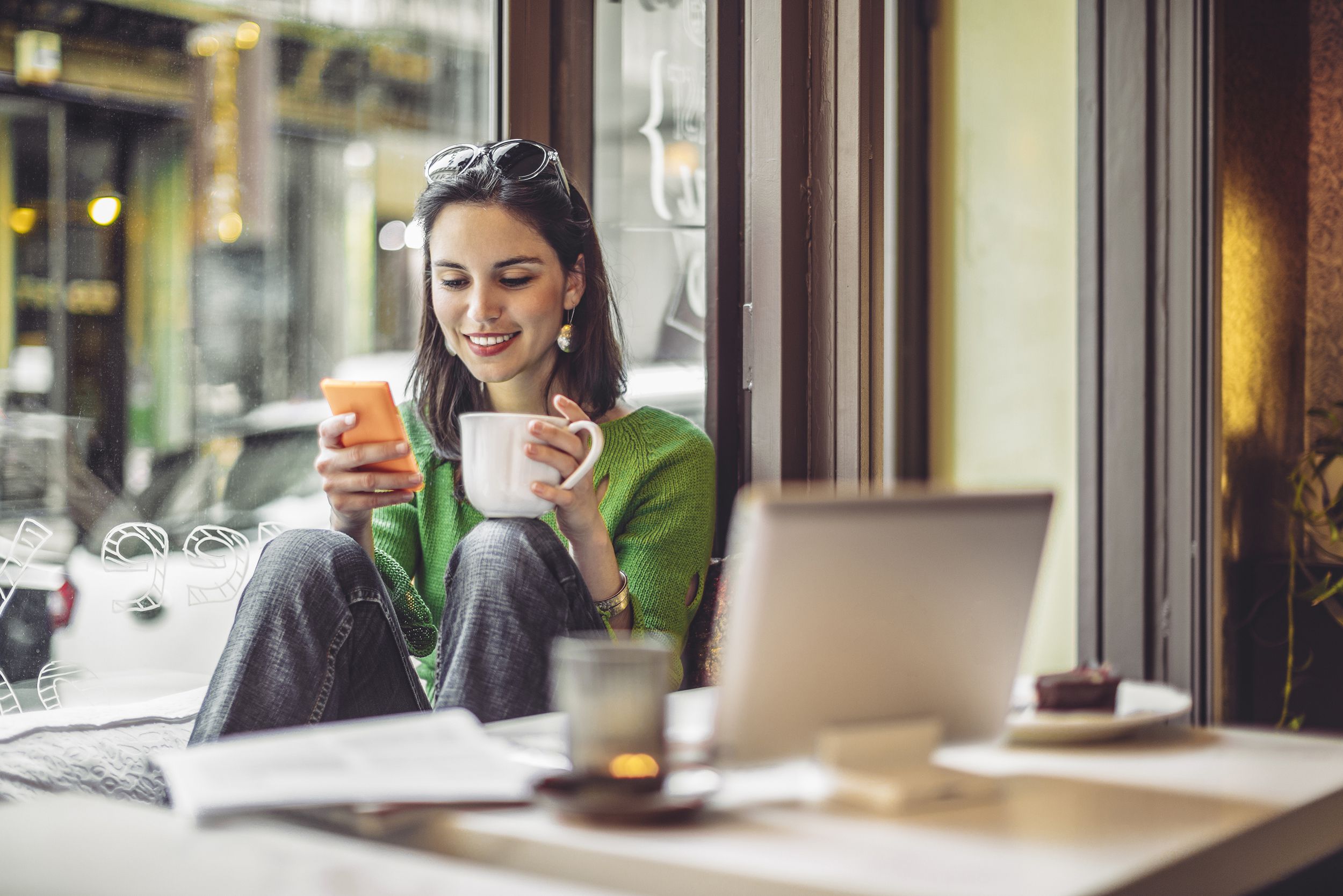 woman doing work at coffee shop