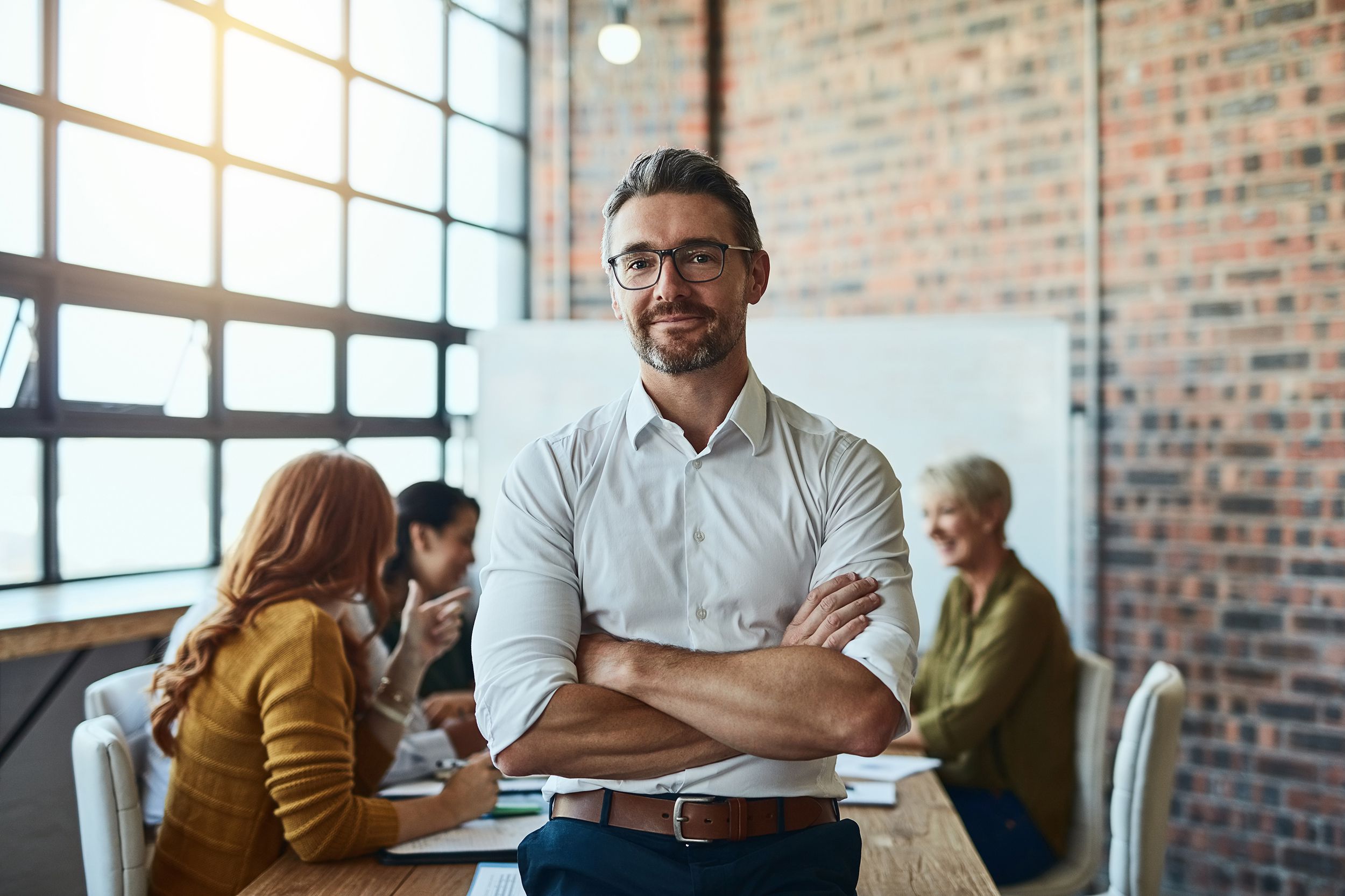 proud man in front of meeting at desk