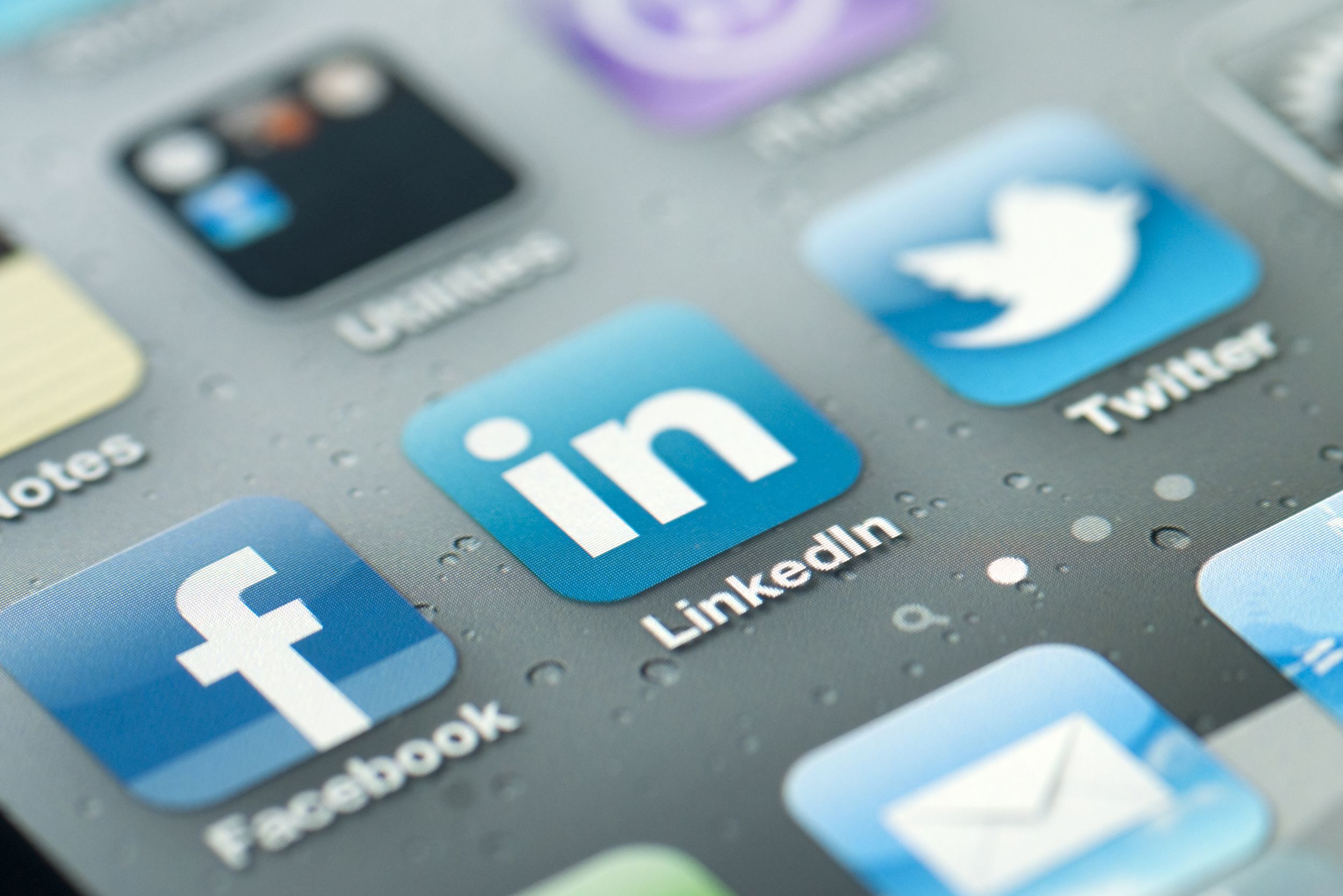 iPhone with apps on it, Facebook, Linkedin, and Twitter