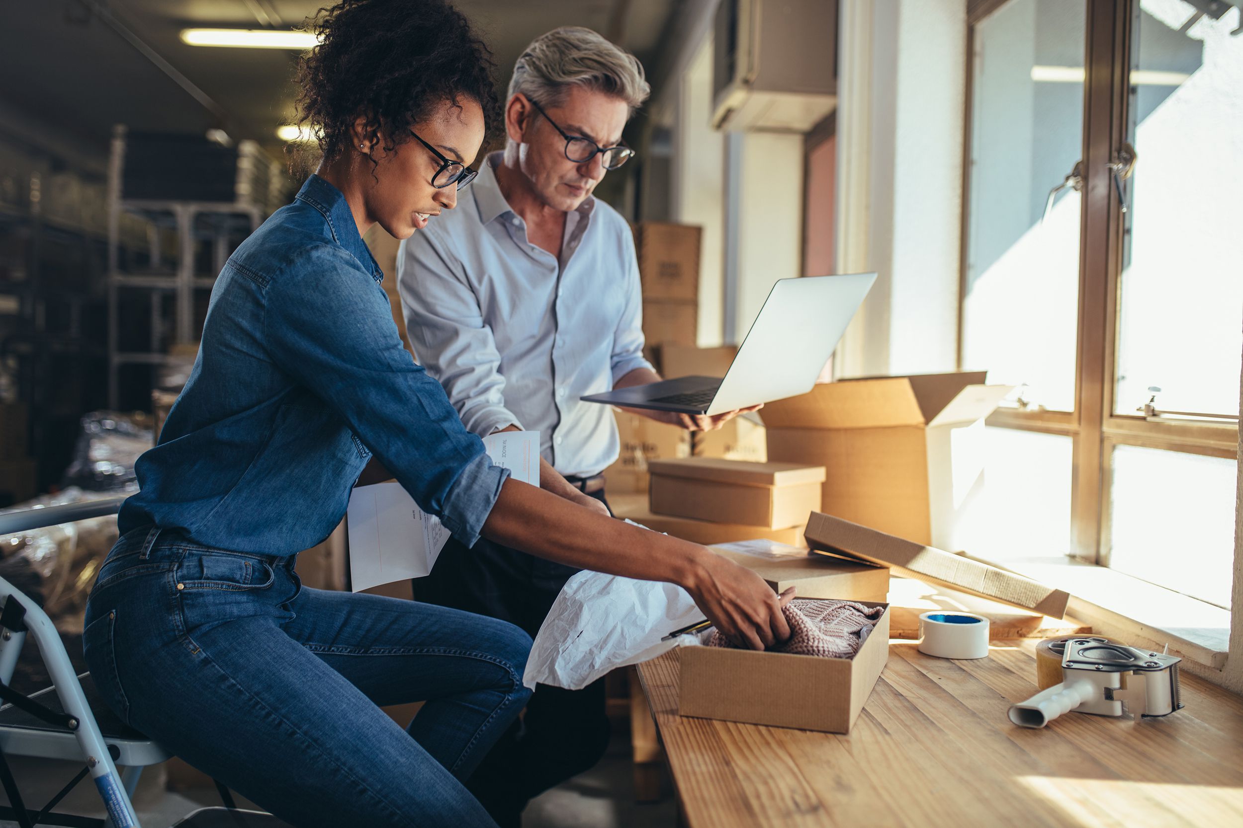 online store partners preparing a parcel for shipping