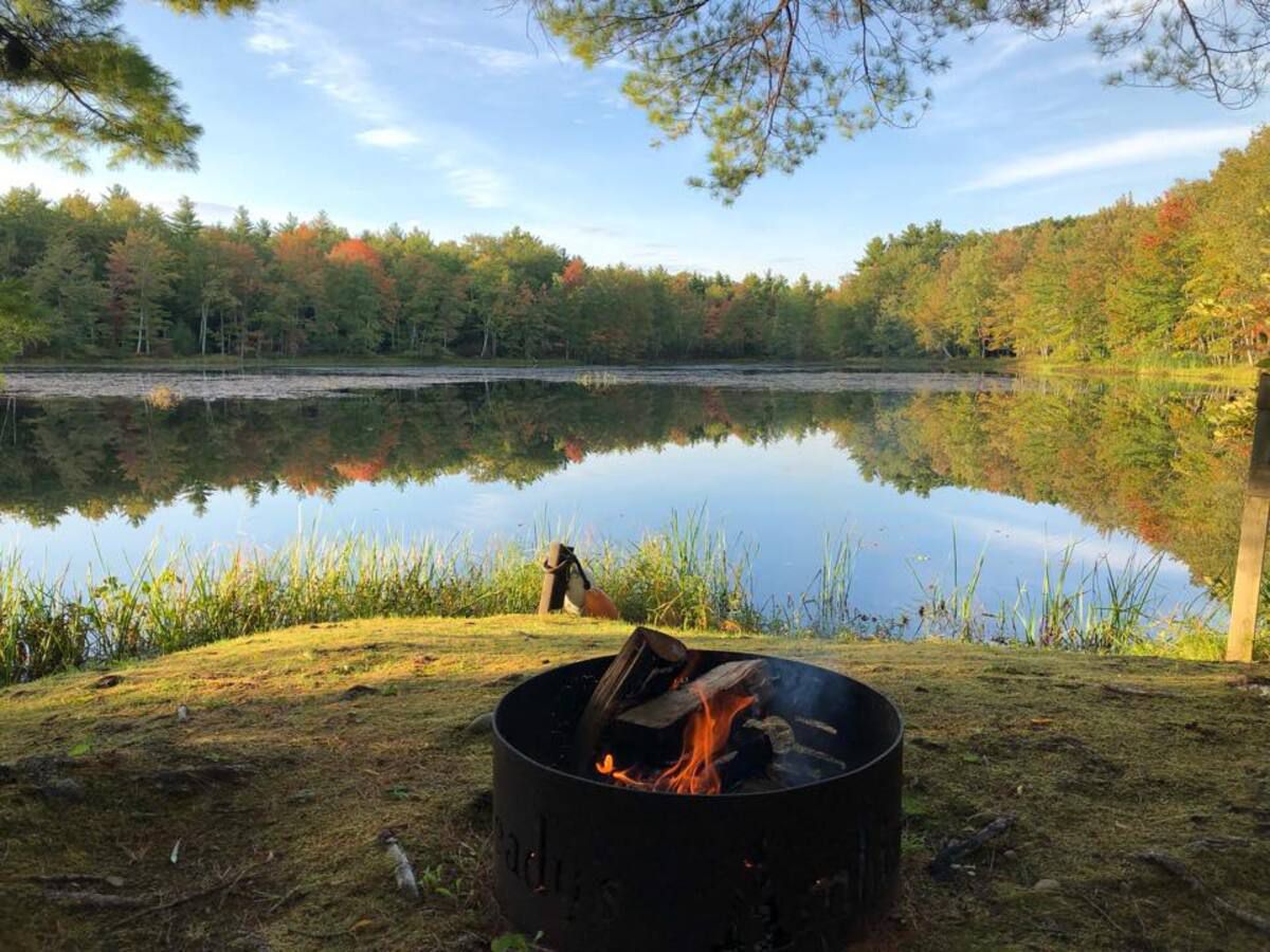 Beaver Dam Campground, Berwick, Maine, fire pit in foreground with lake in the background
