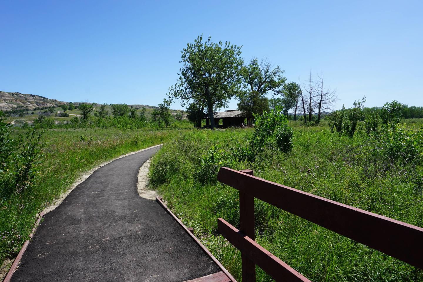 Downstream Campground, Riverdale, North Dakota, a paved trail with park in the background
